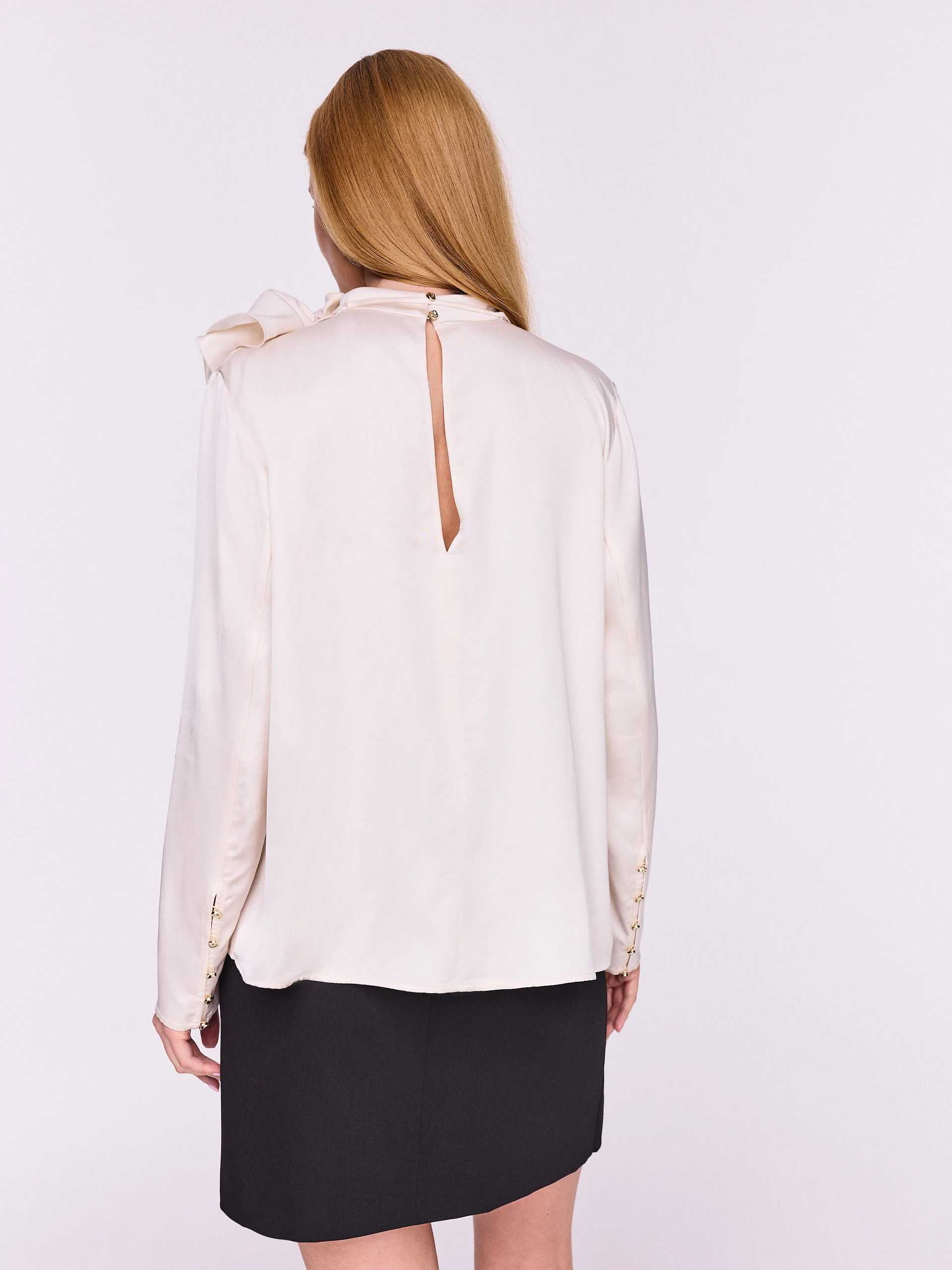 Cream blouse with an eye-catching flower appliqué
