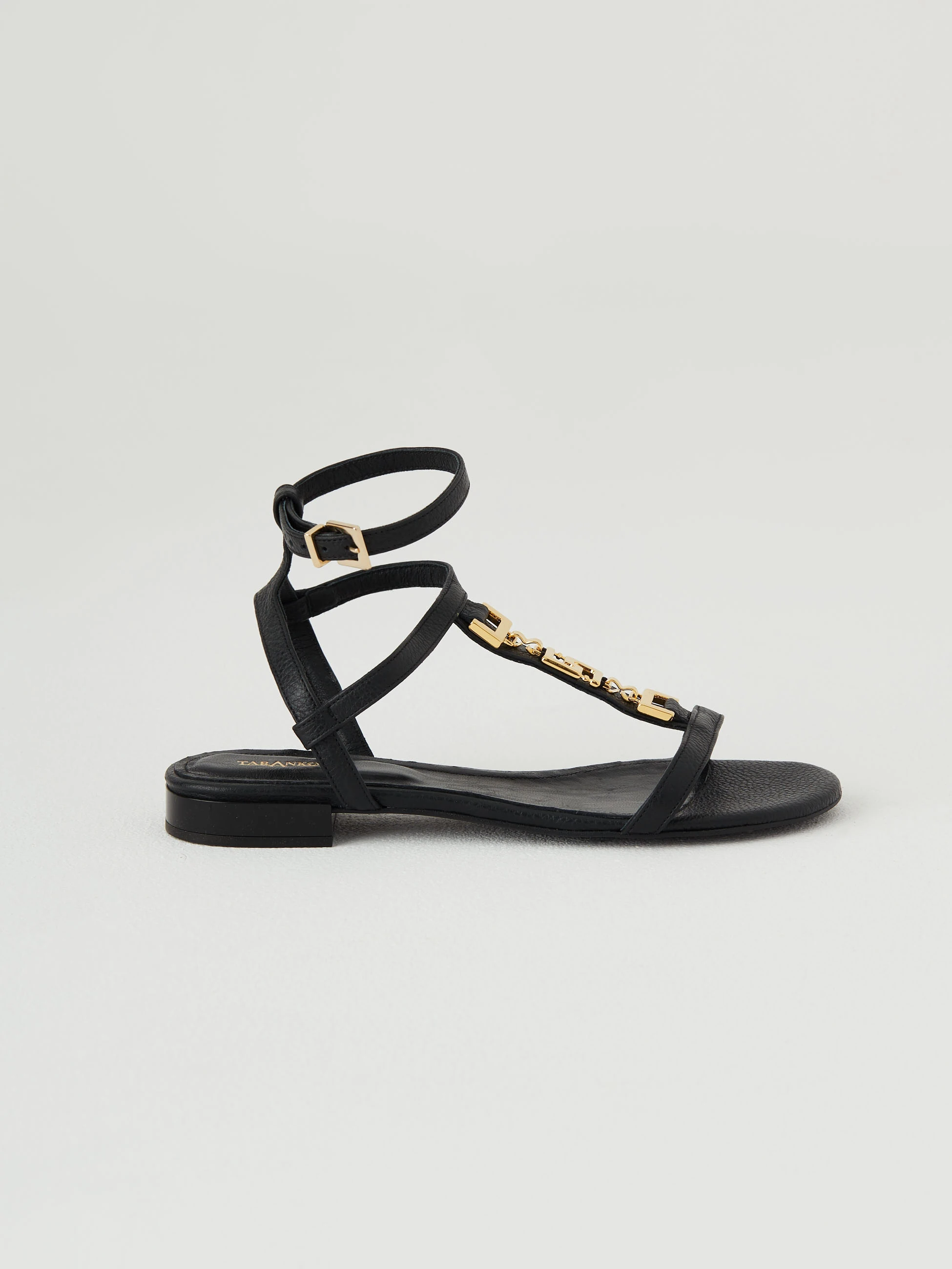 Black leather sandals with gold elements
