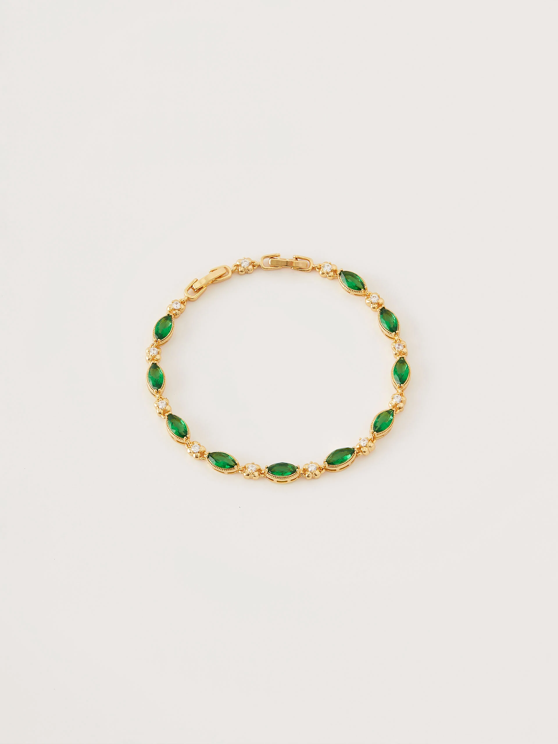 Bracelet in gold color with green crystals