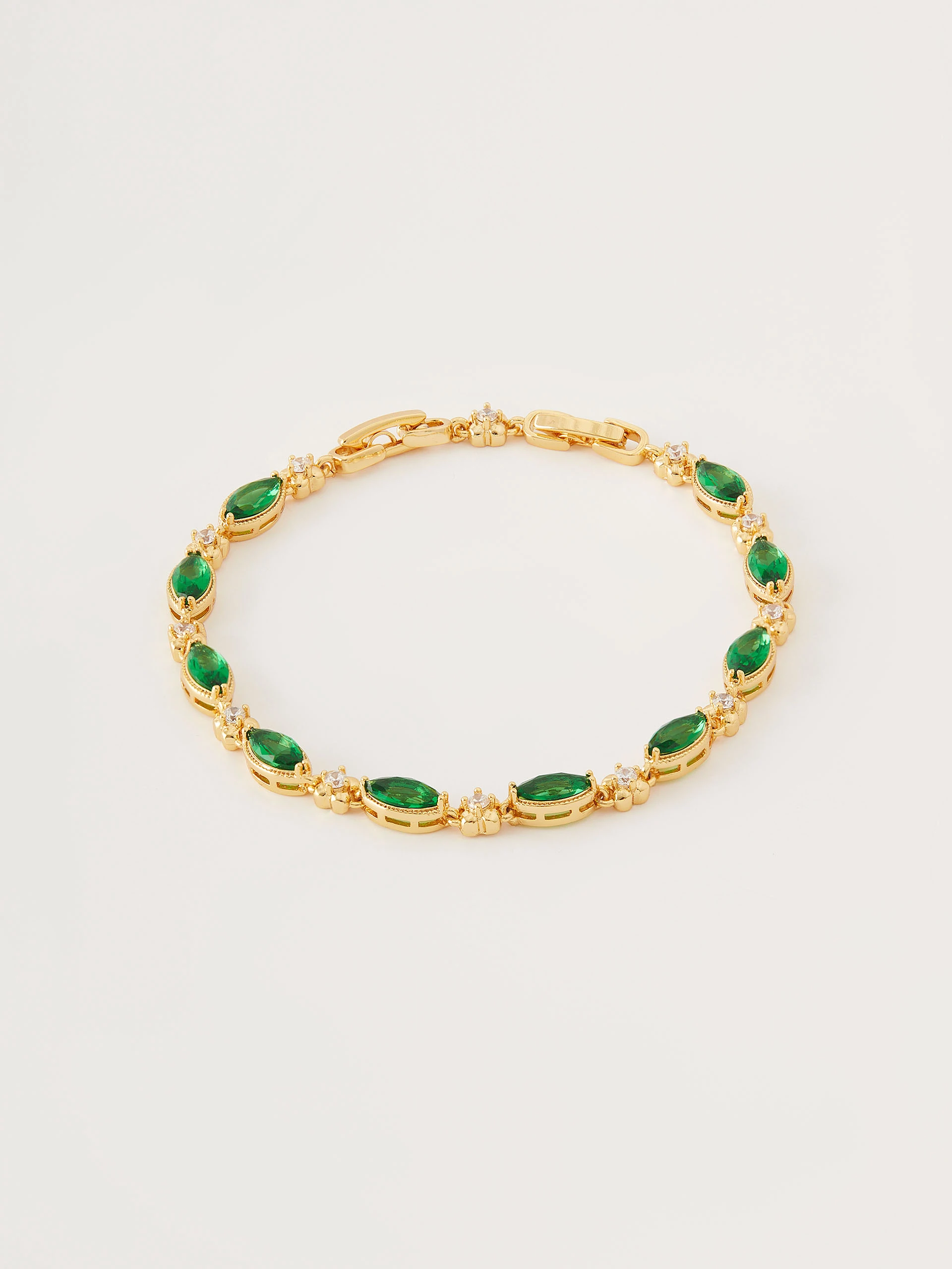 Bracelet in gold color with green crystals