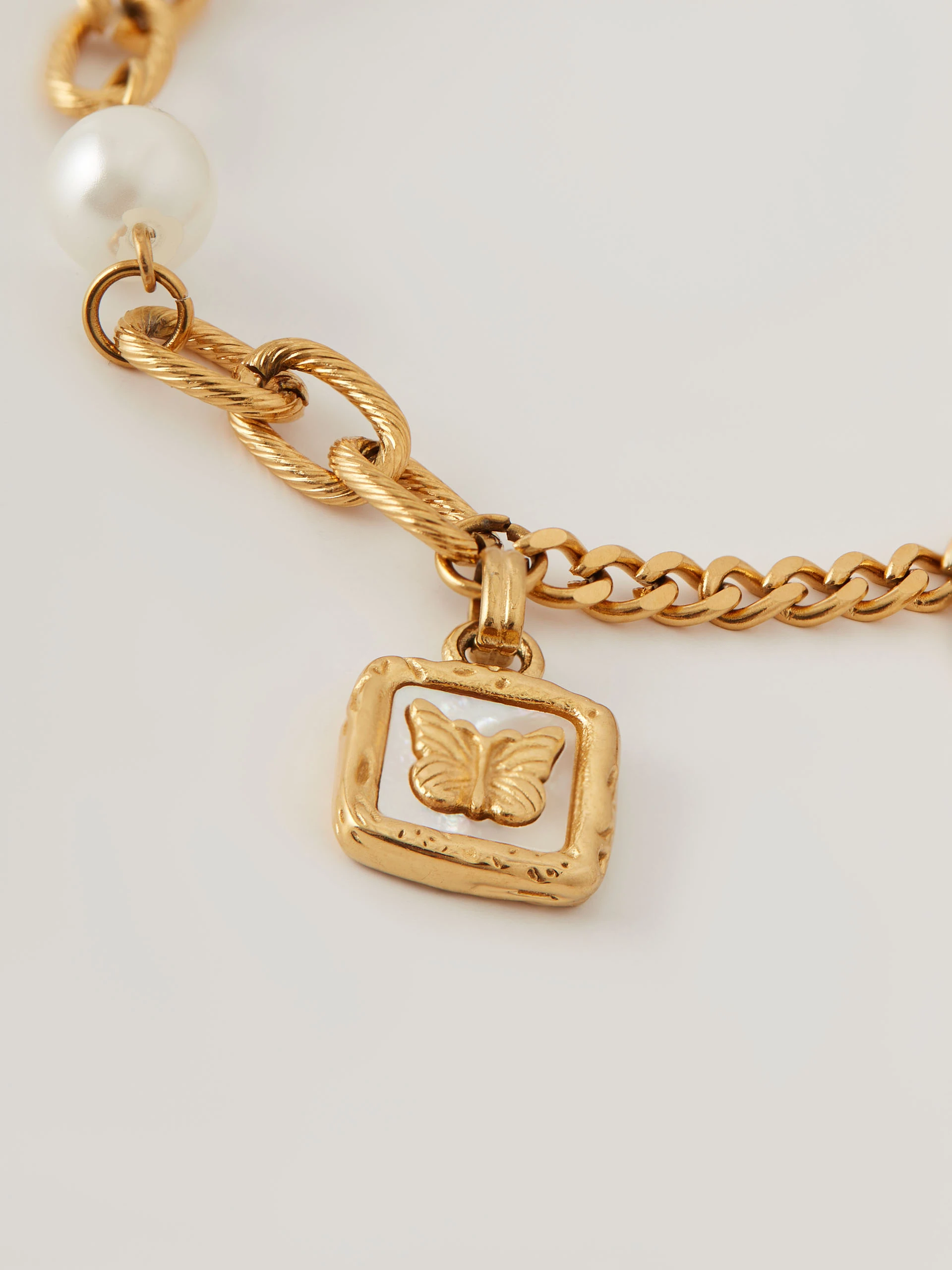 Bracelet with pearl and butterfly pendant