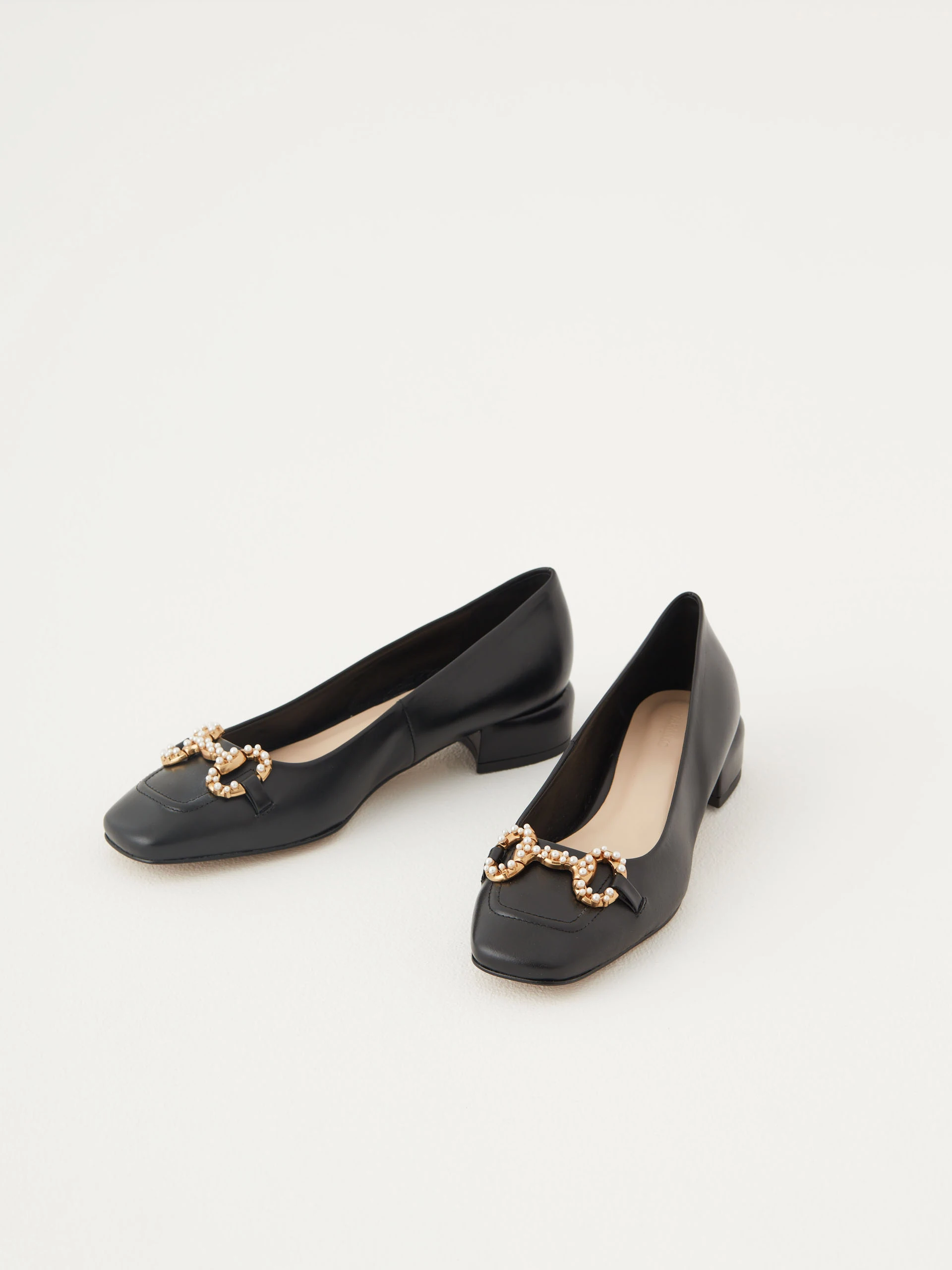 Black leather ballerinas decorated with buckles