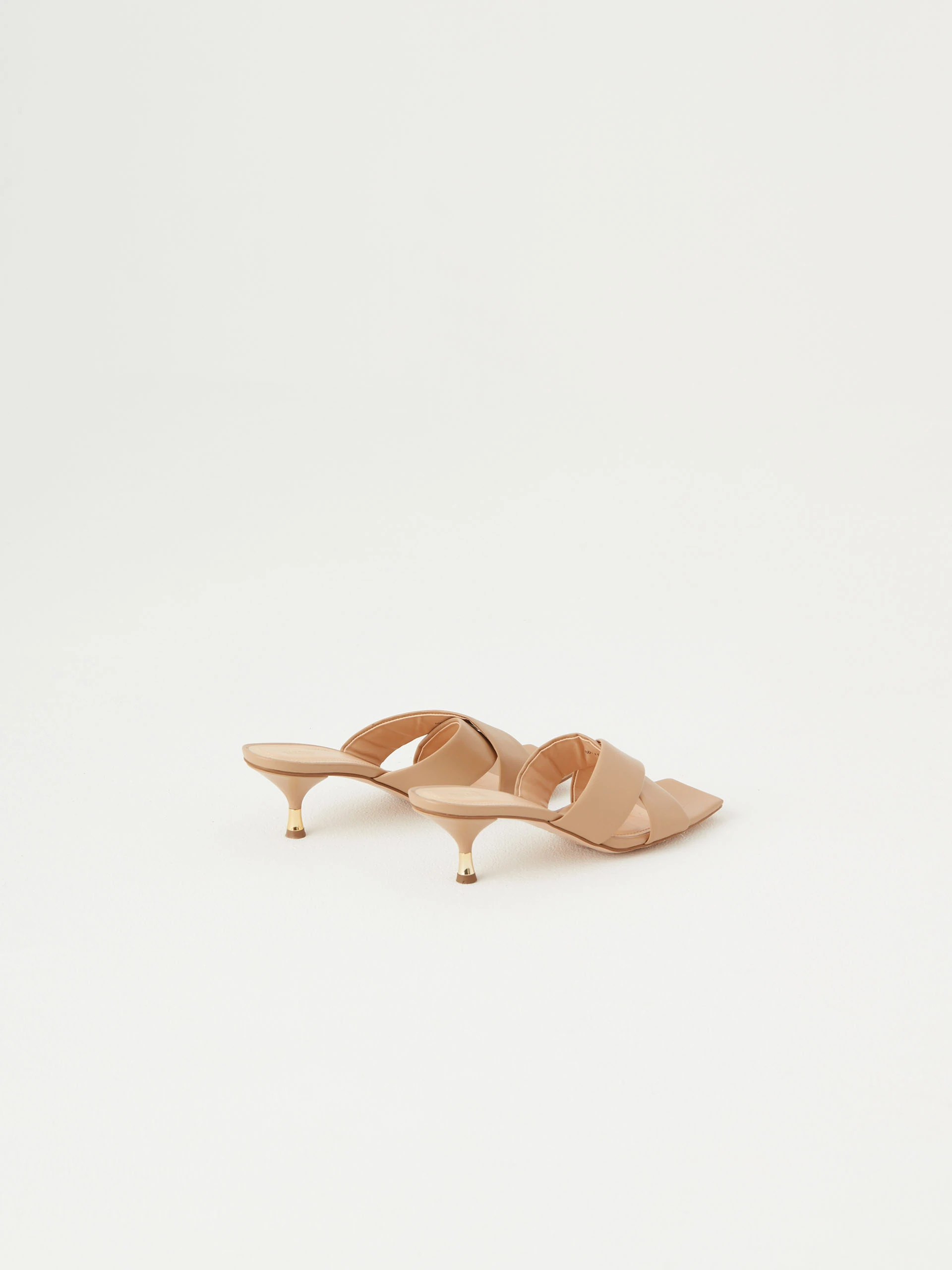Beige flip-flops with decorative gold element on the heel