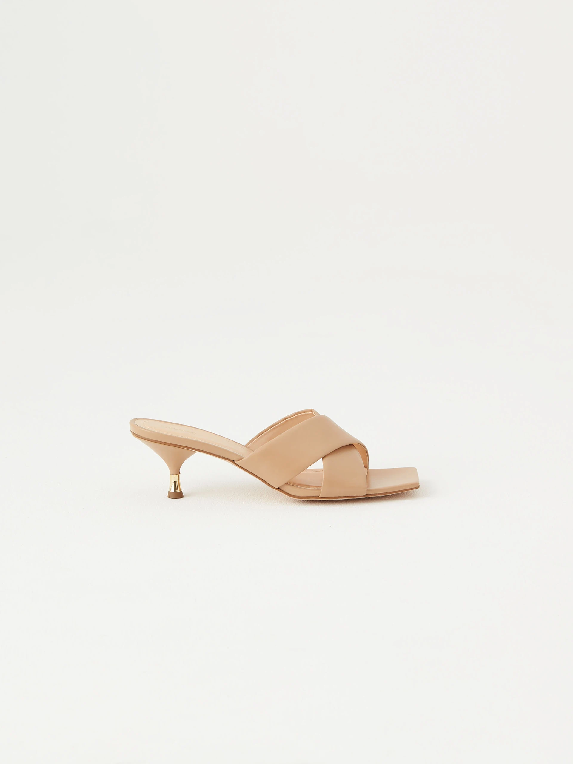 Beige flip-flops with decorative gold element on the heel