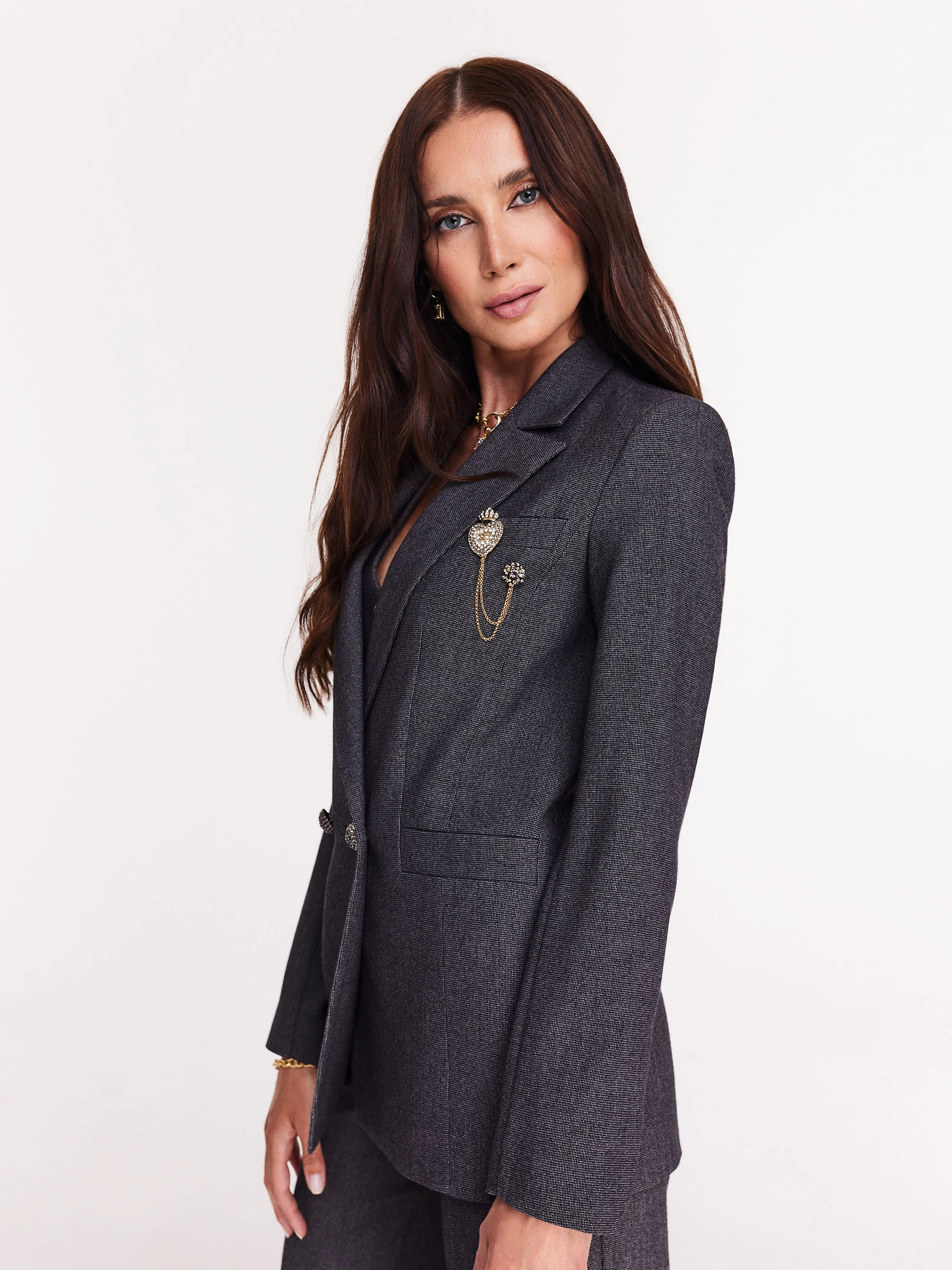 Gray jacket with jewelry brooch