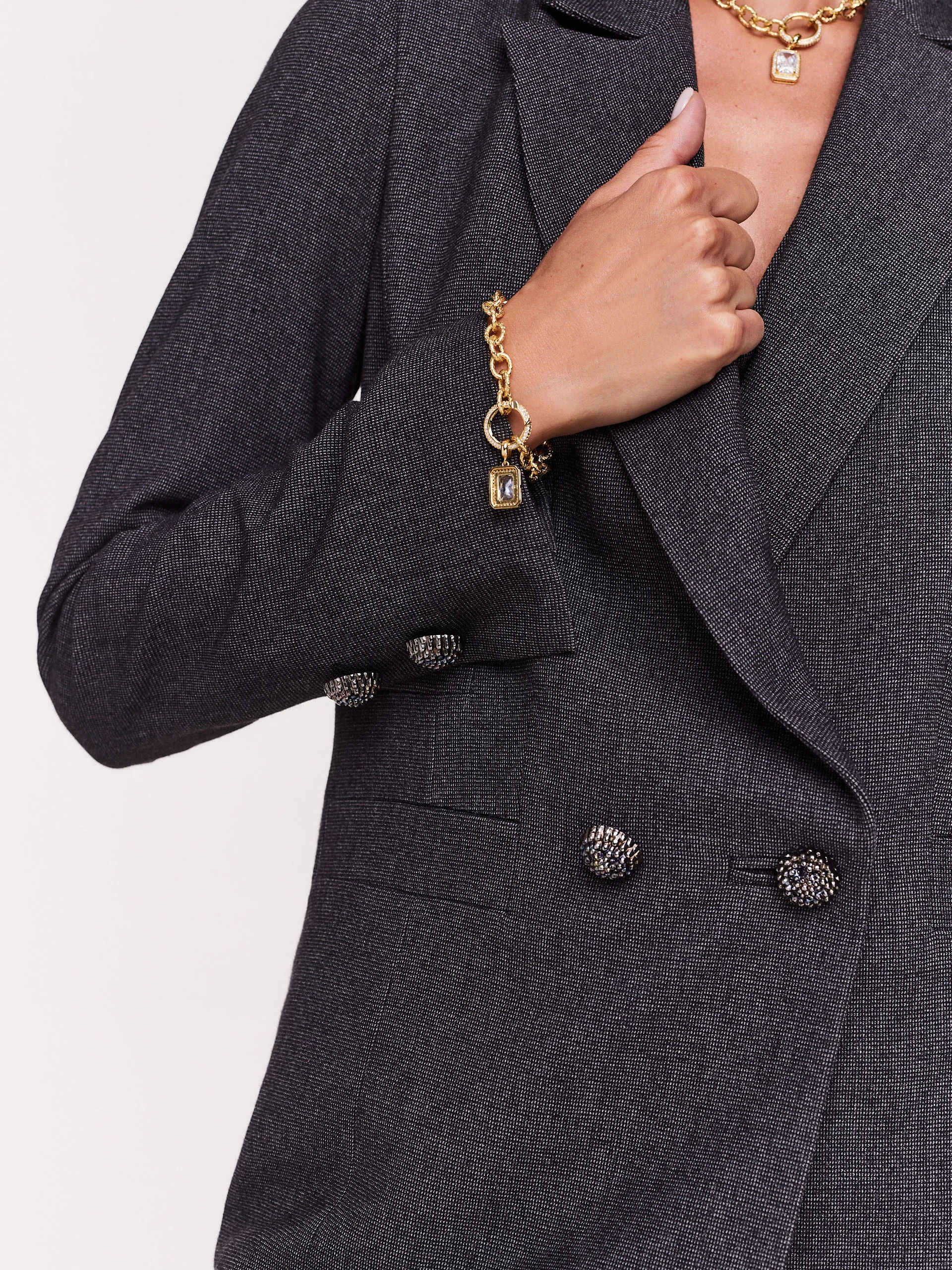 Gray jacket with jewelry brooch