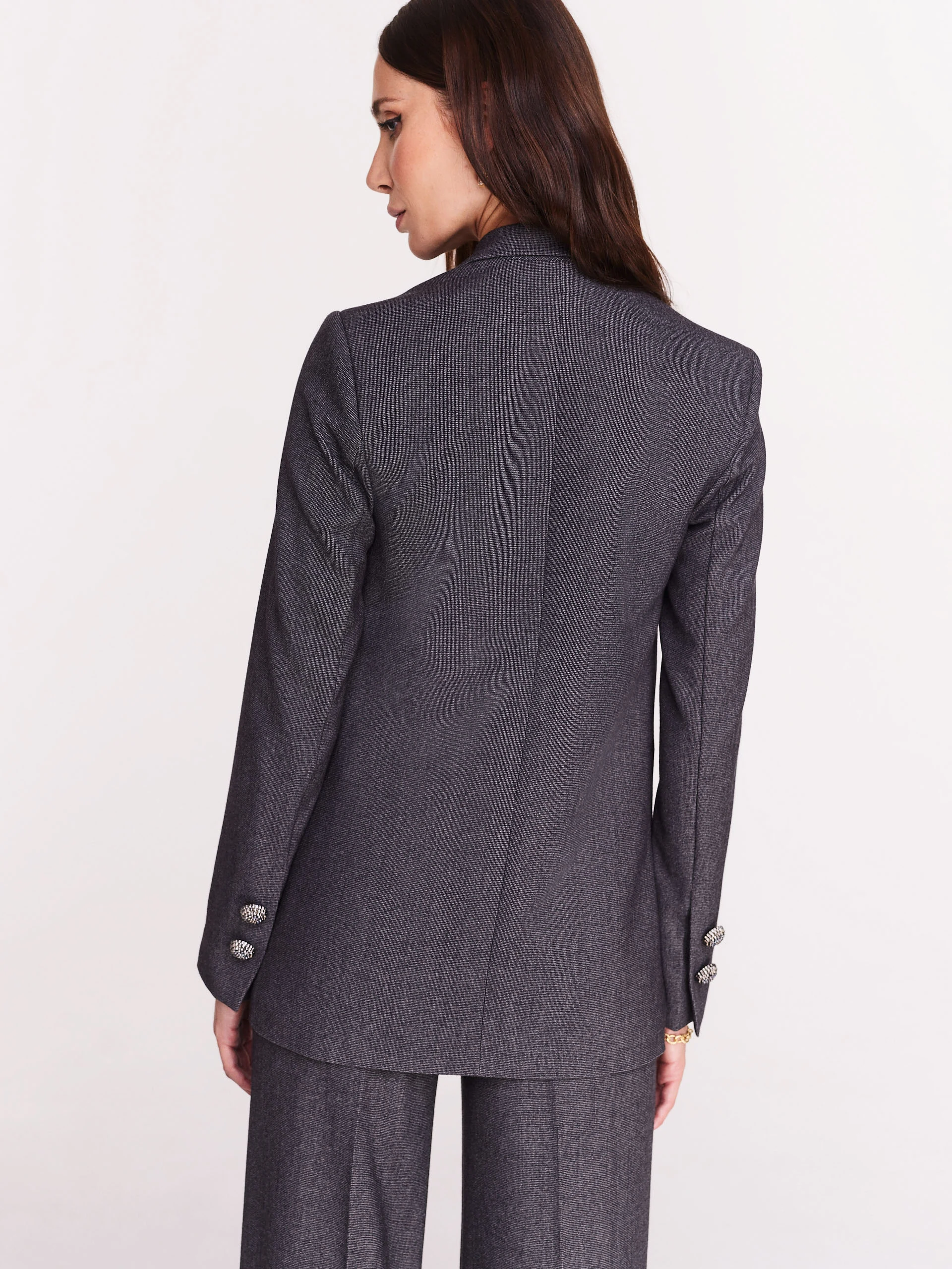 Gray jacket with jewelry brooch
