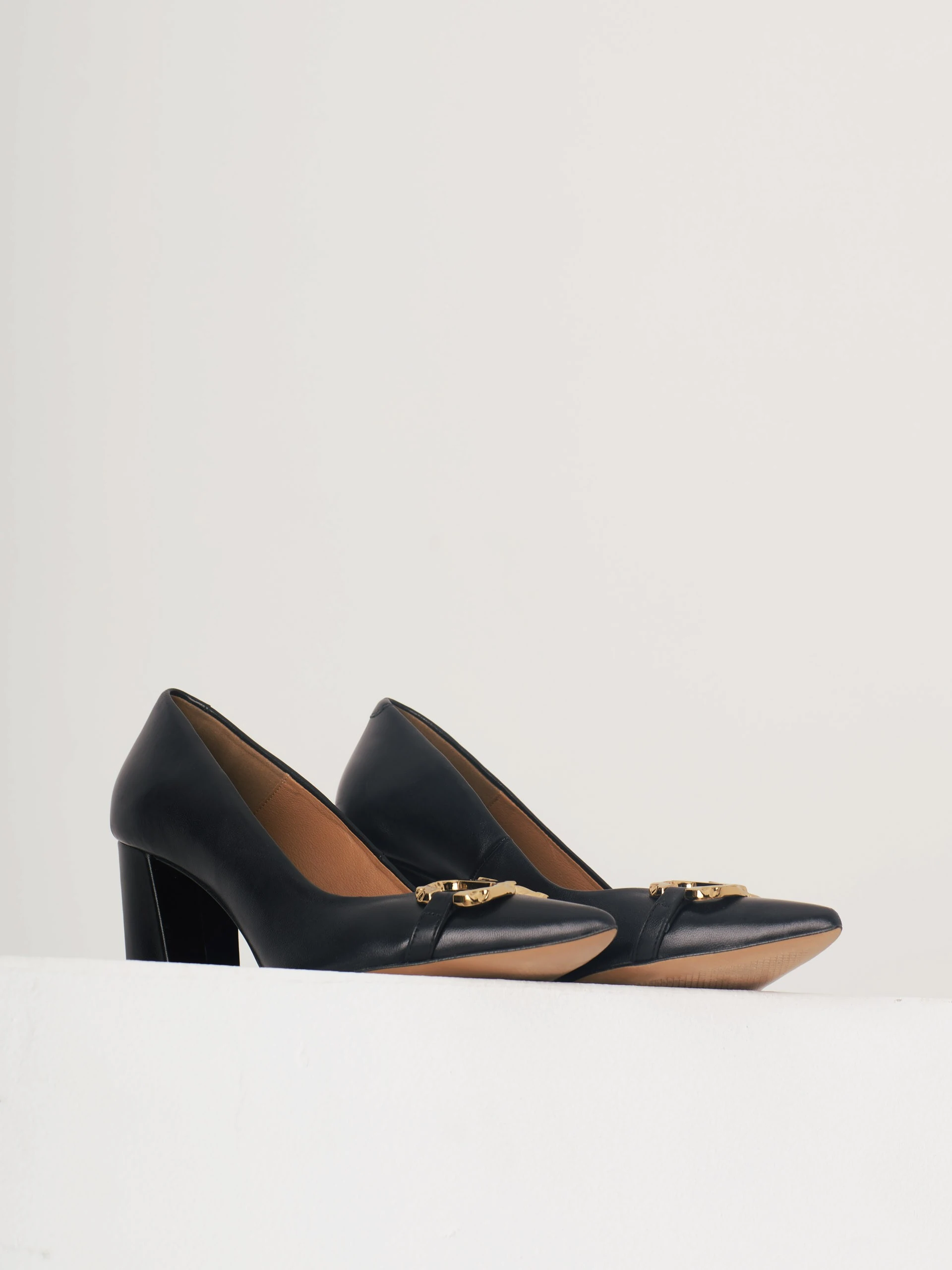 Black heels with golden buckle