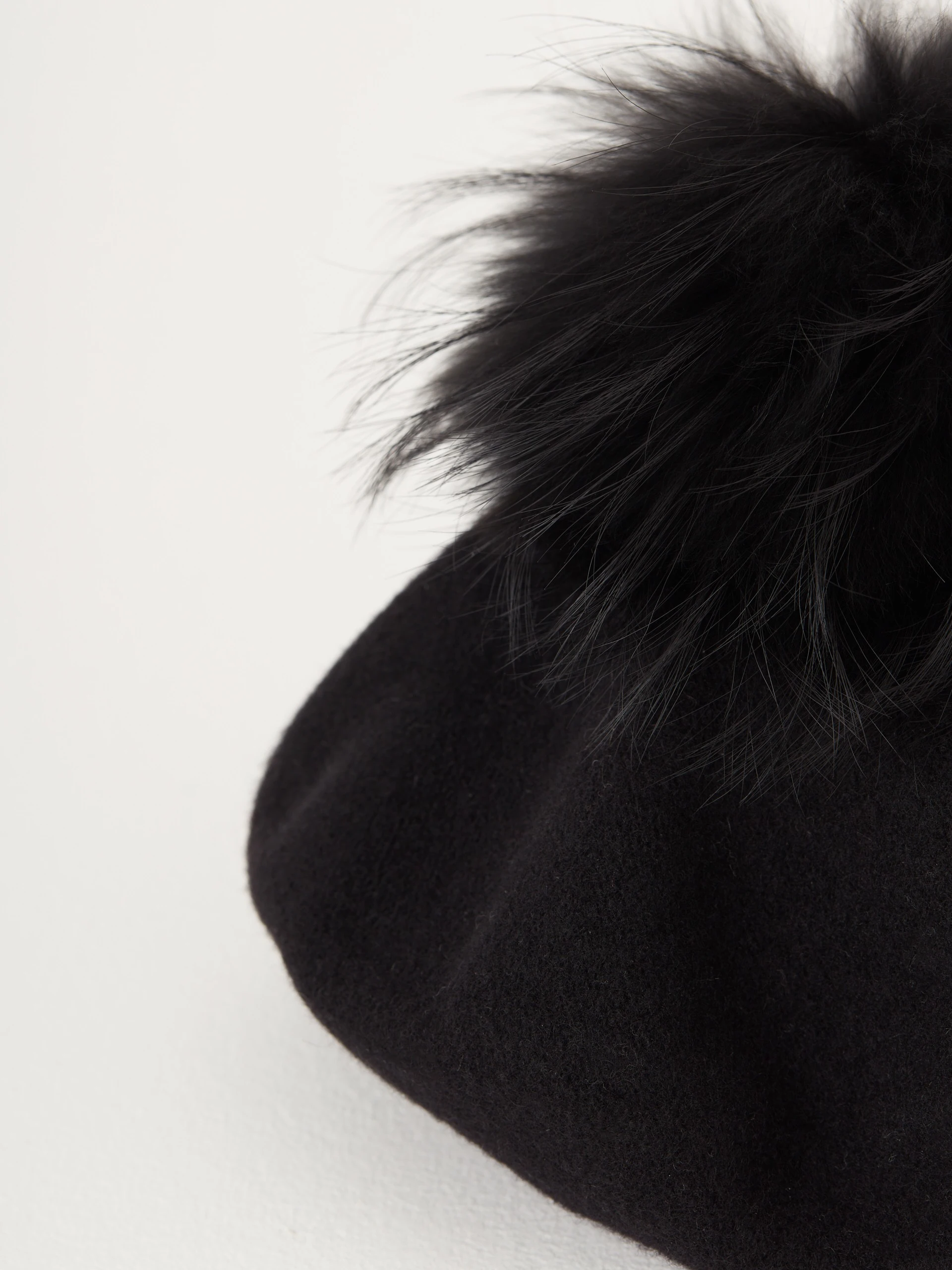 Black beret with decorative pom-pom
