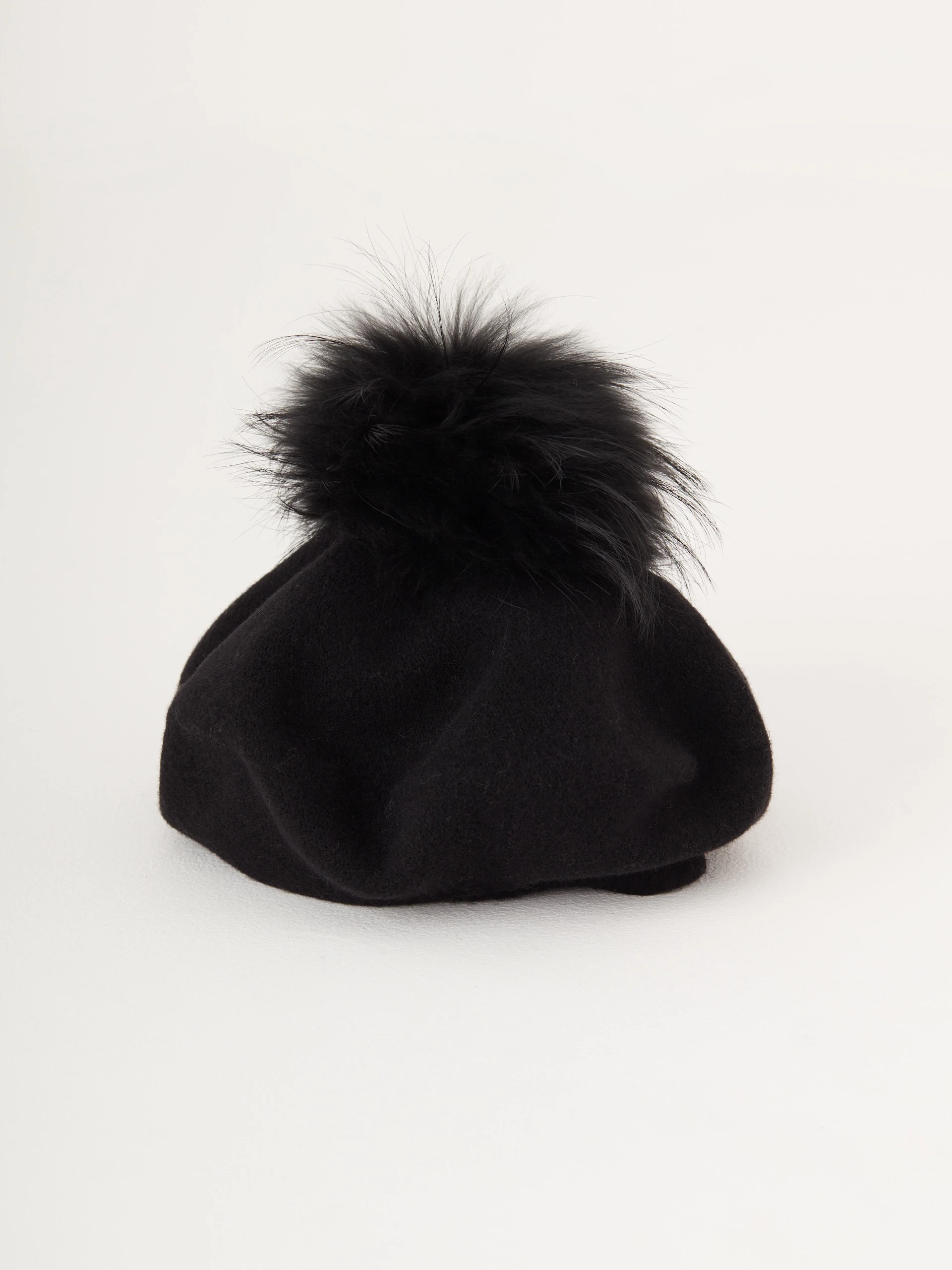 Black beret with decorative pom-pom