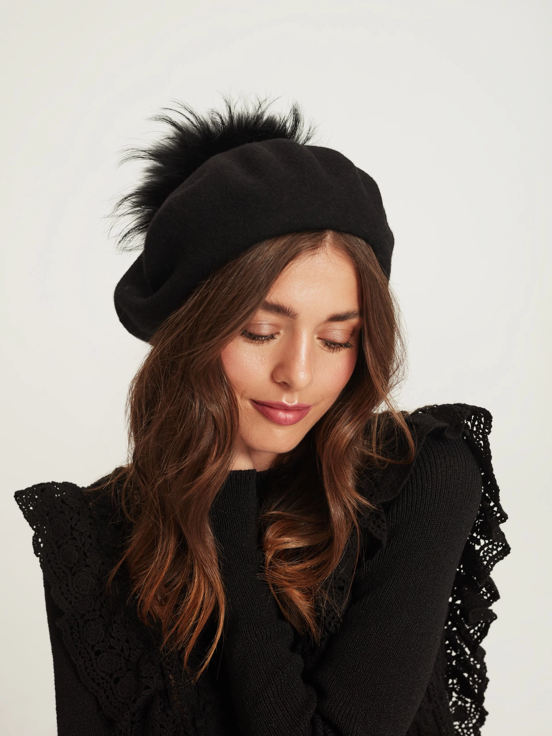 Black beret with decorative pom-pom