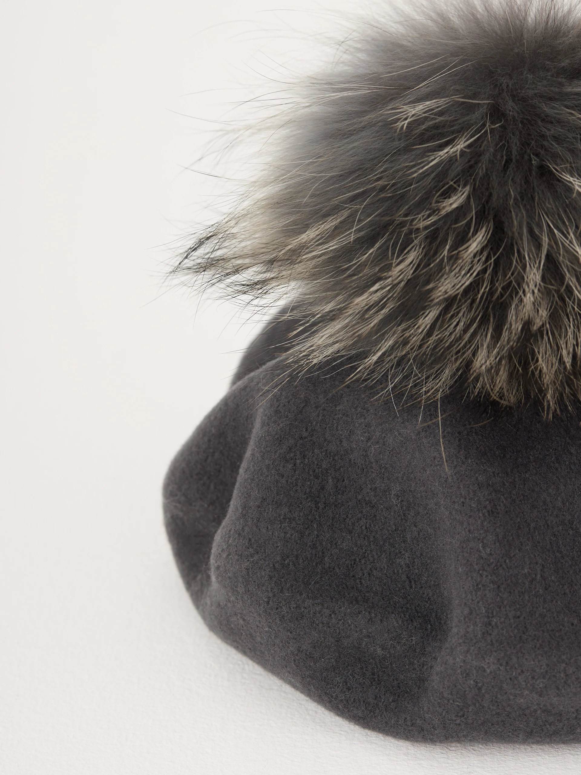 Grey beret with decorative pom-pom