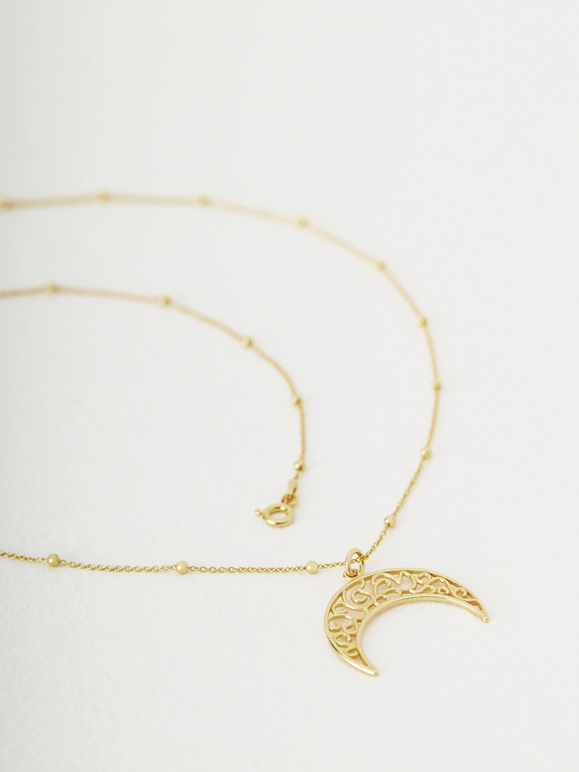 Necklace with openwork crescent moon
