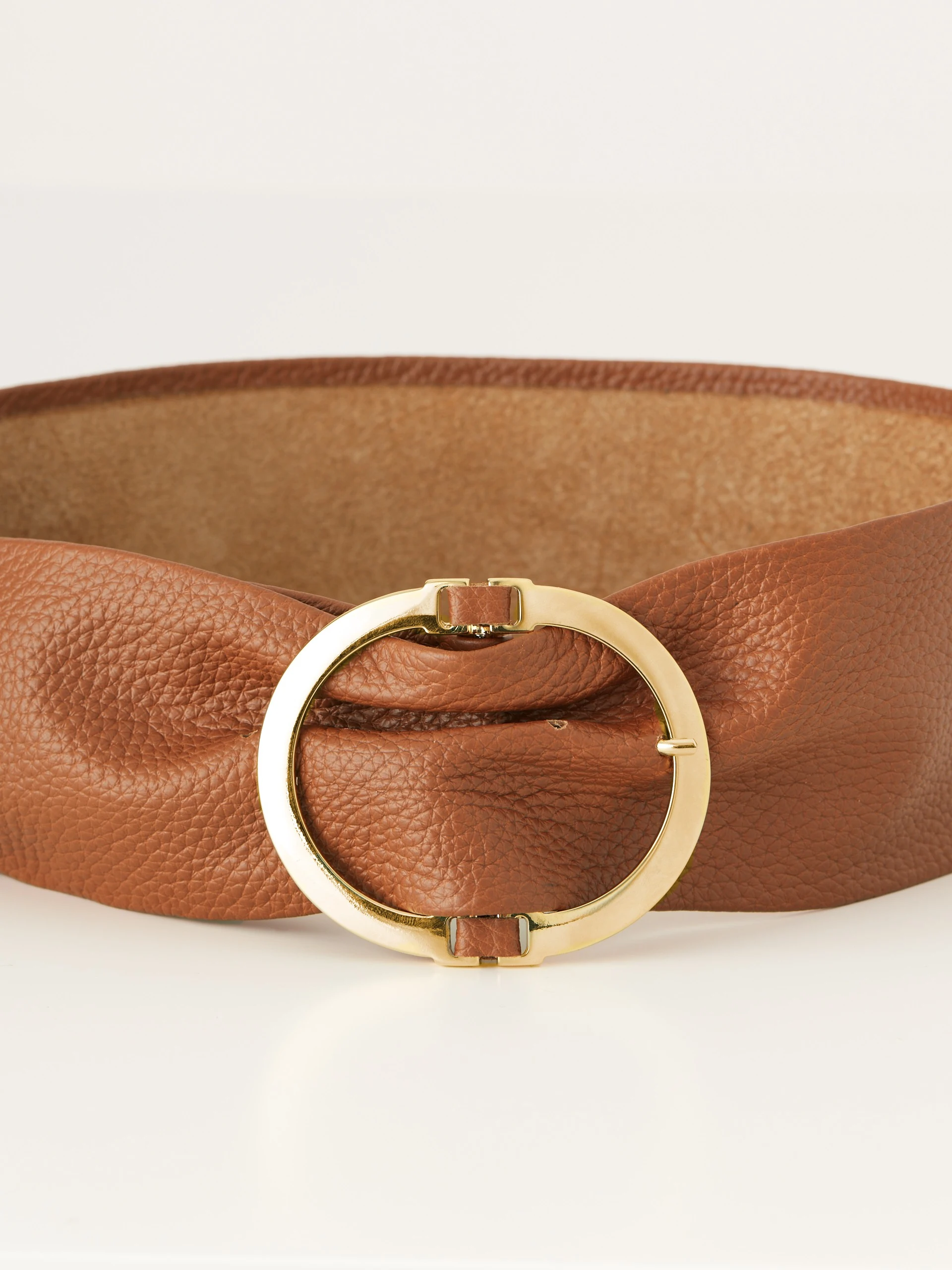 Wide brown belt with round buckle
