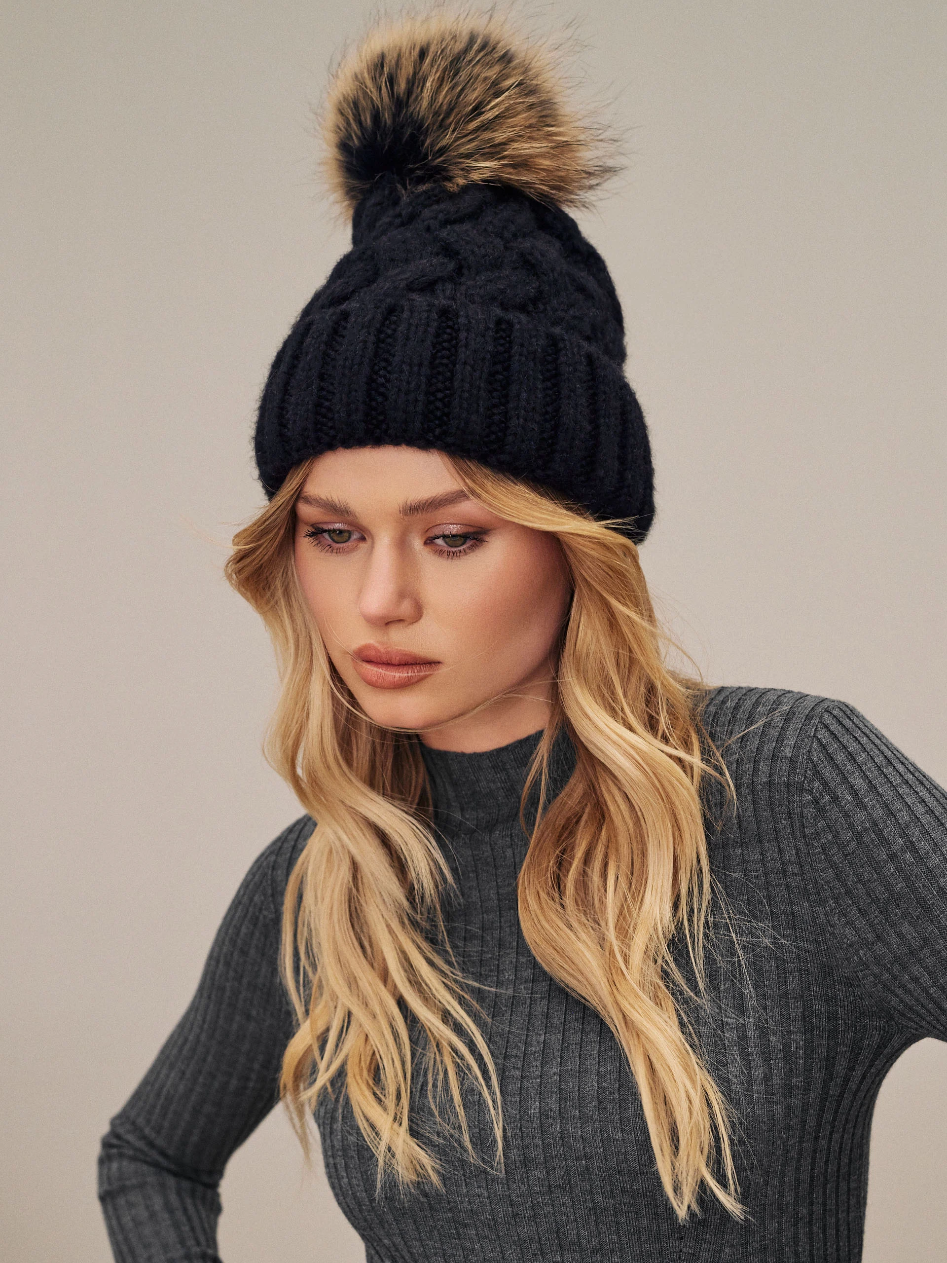 Black beanie with added wool and fur pompom