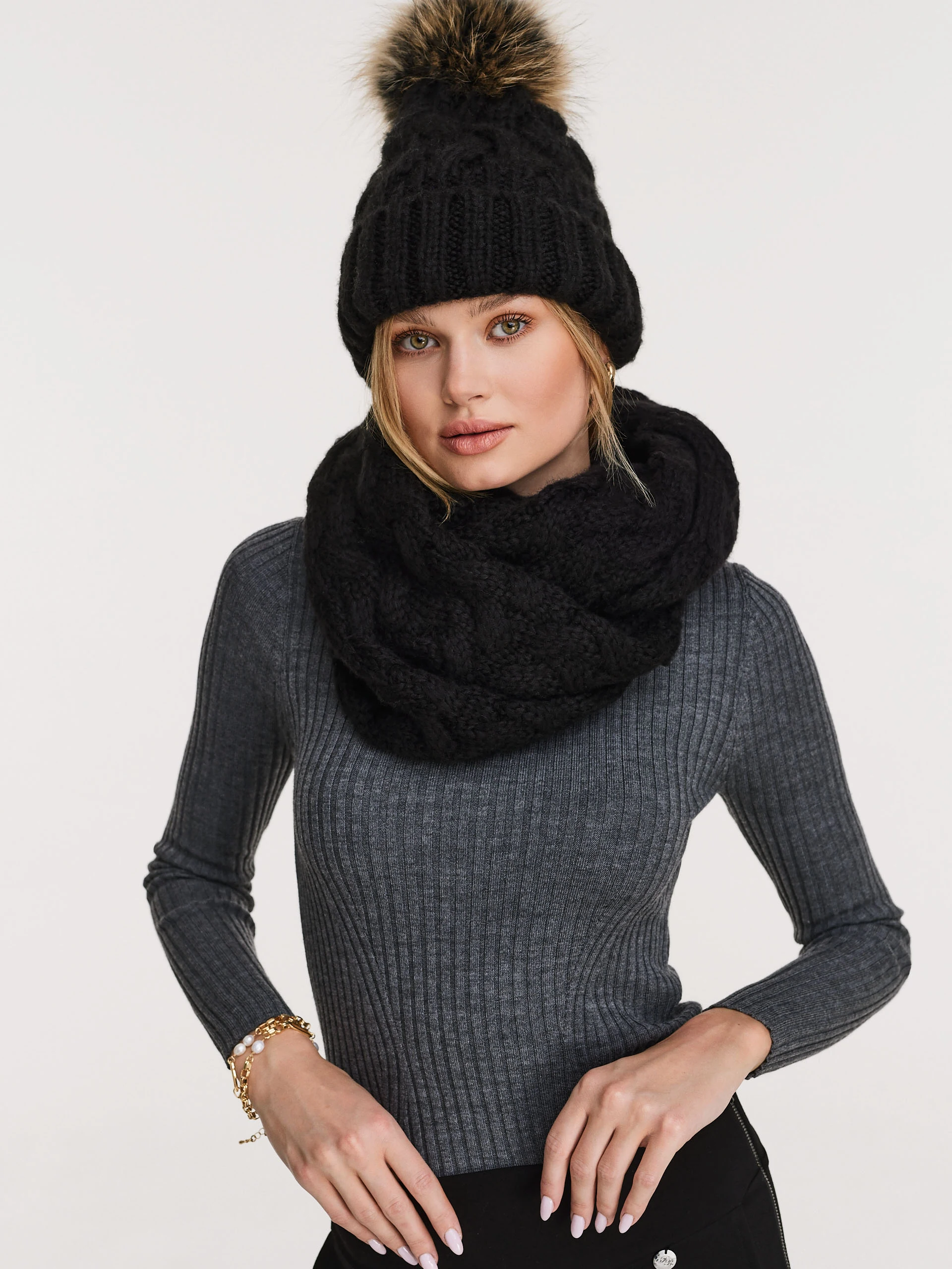 Black beanie with added wool and fur pompom