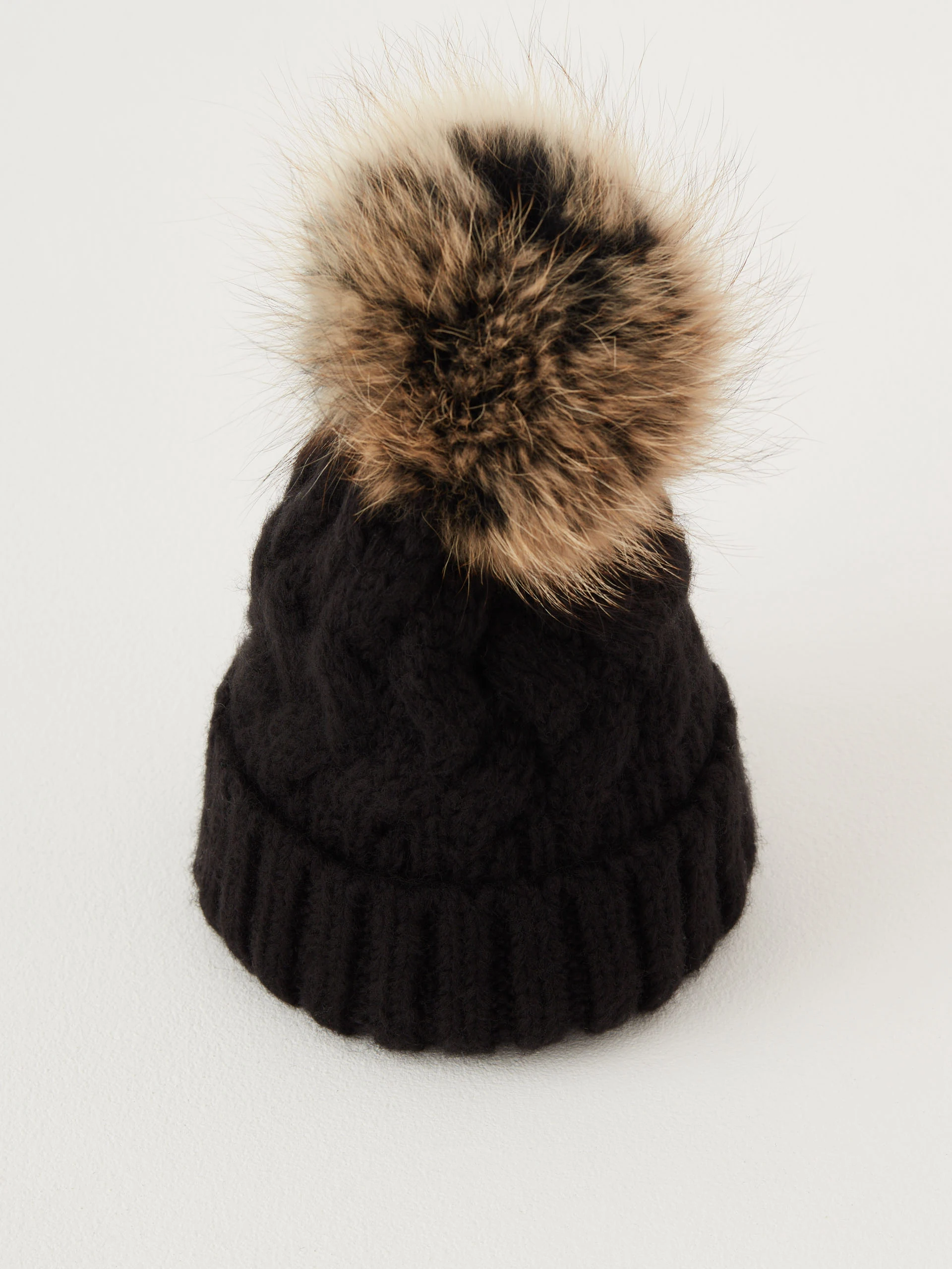 Black beanie with added wool and fur pompom