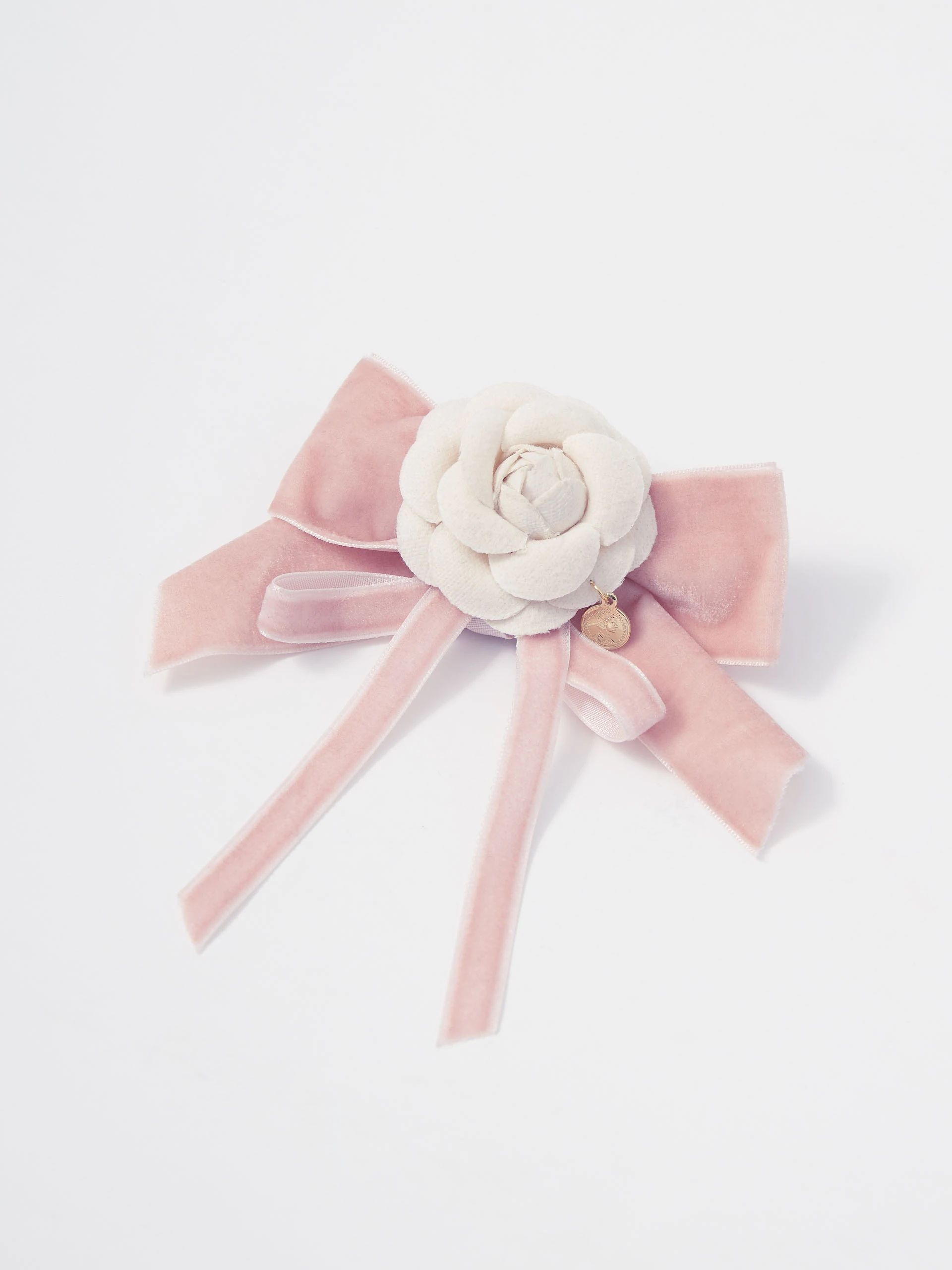 Brooch in the shape of a bow with a flower and a pendant