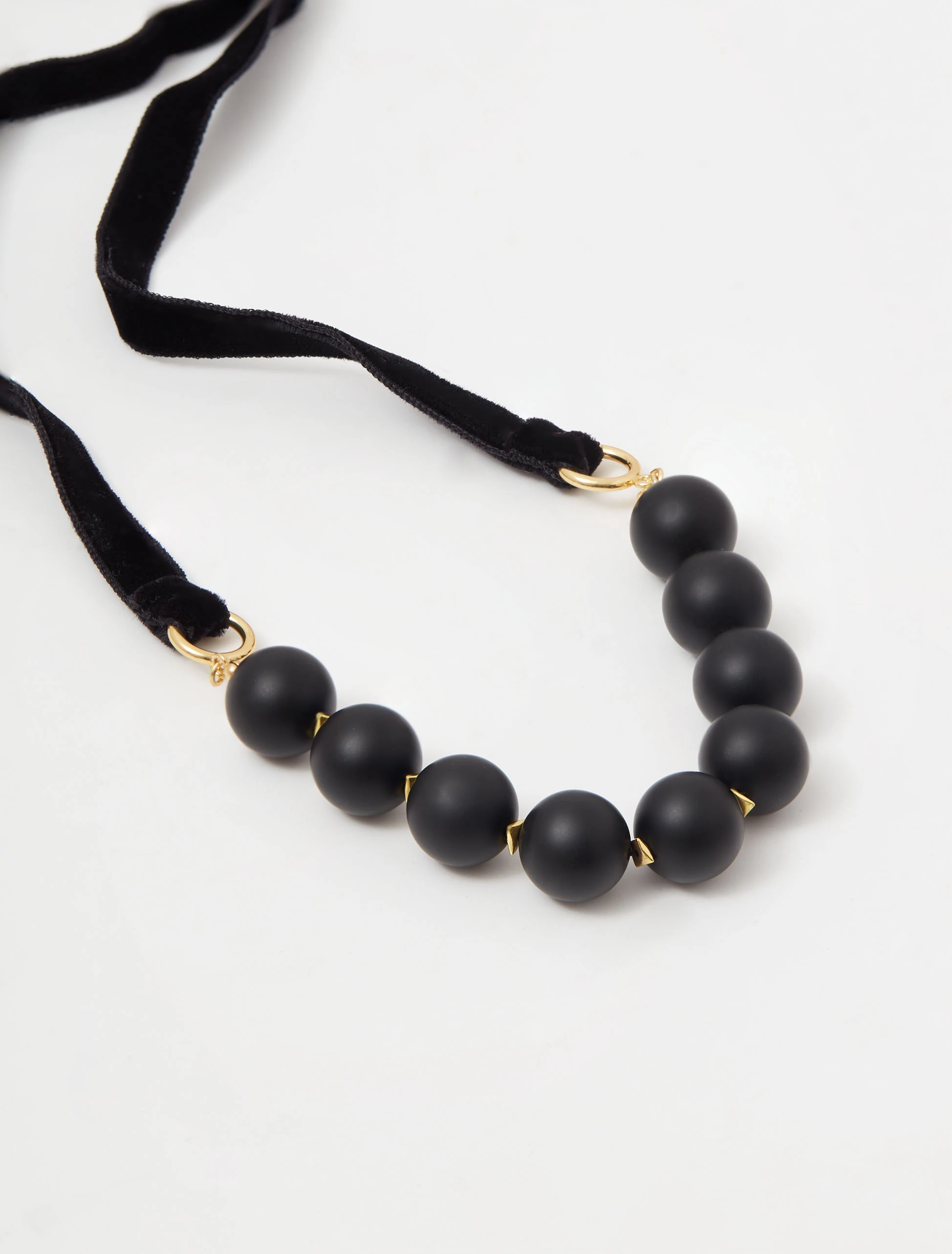 Gold-plated necklace with onyx and hematite stones on a ribbon