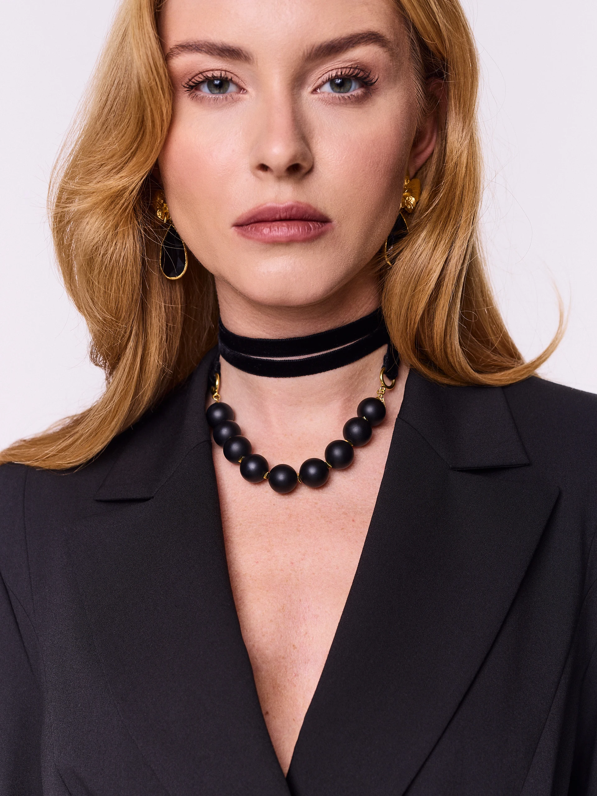Gold-plated necklace with onyx and hematite stones on a ribbon