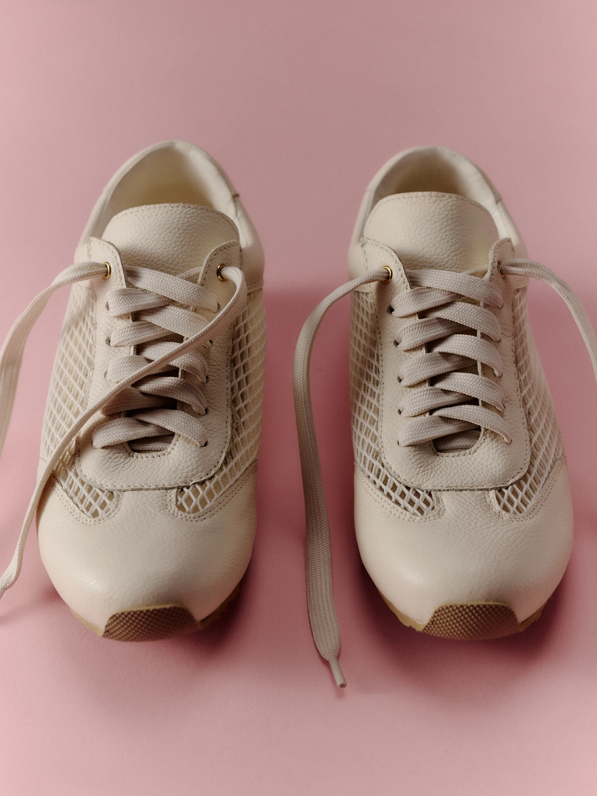 Leather cream sneakers with decorative tags