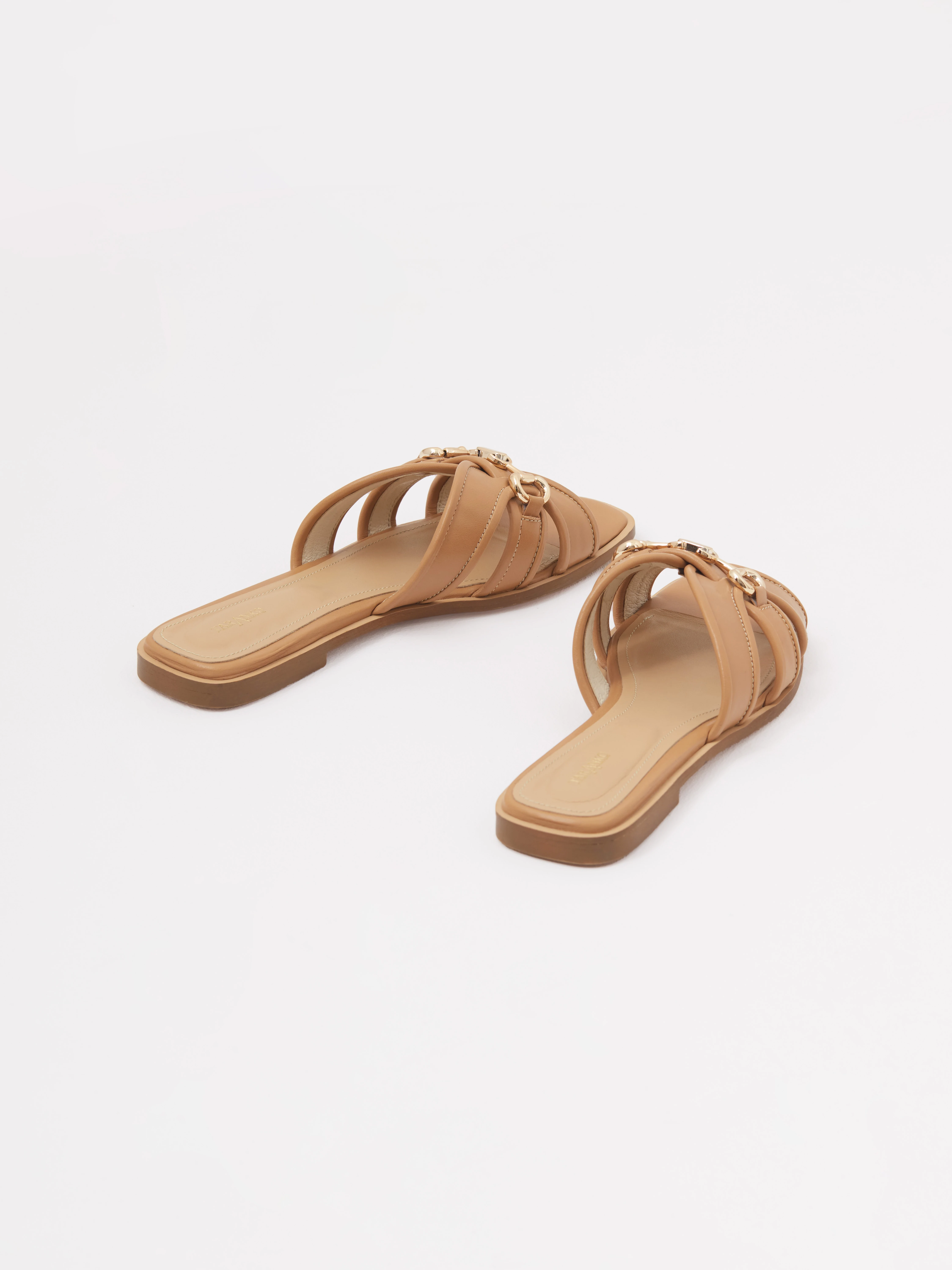 Caramel-colored leather flip-flops with a decorative buckle