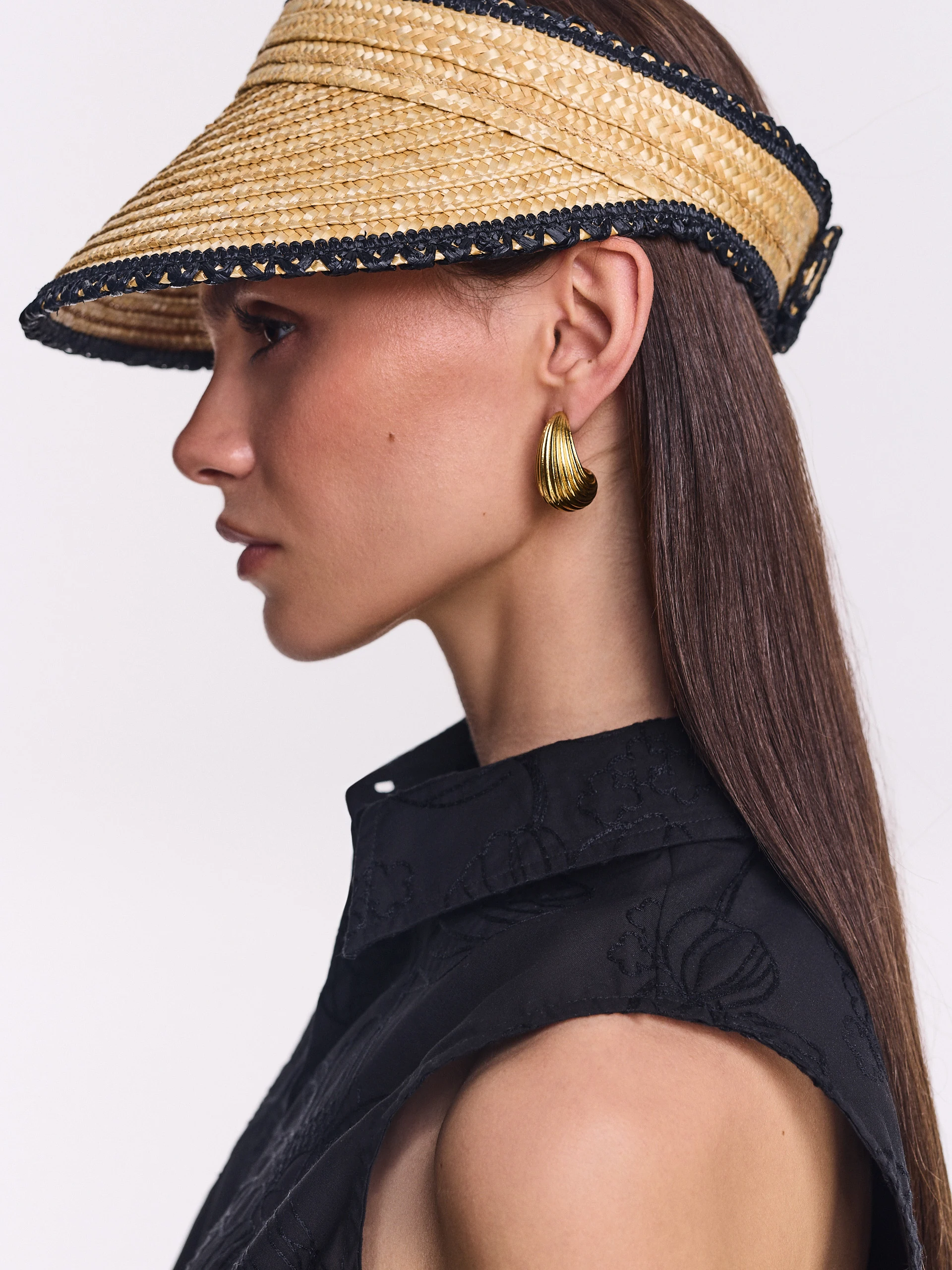 A visor made of natural fibers with decorative trim
