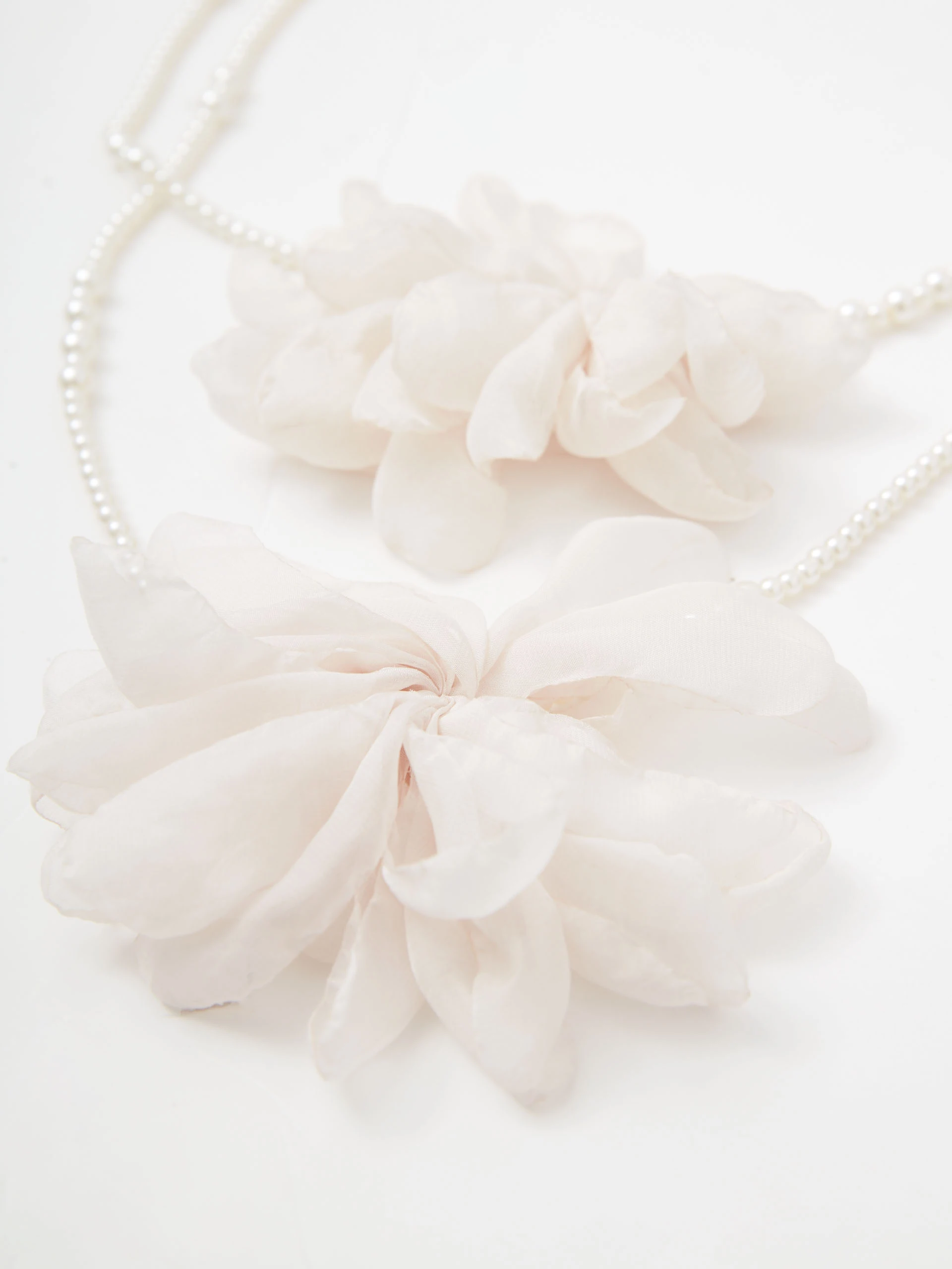 Double necklace made of glass pearls with flowers