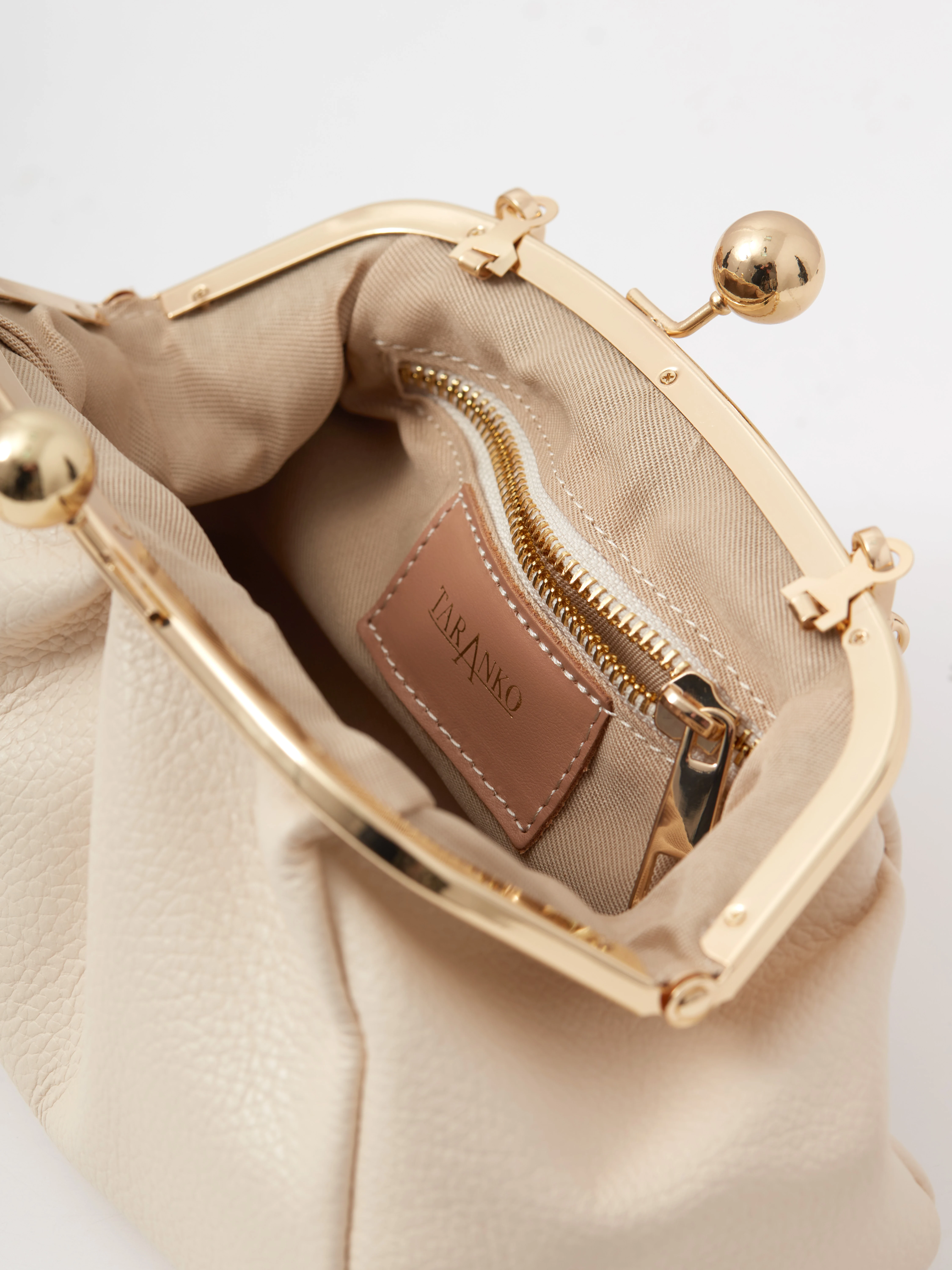 Cream-colored leather handbag with a chain