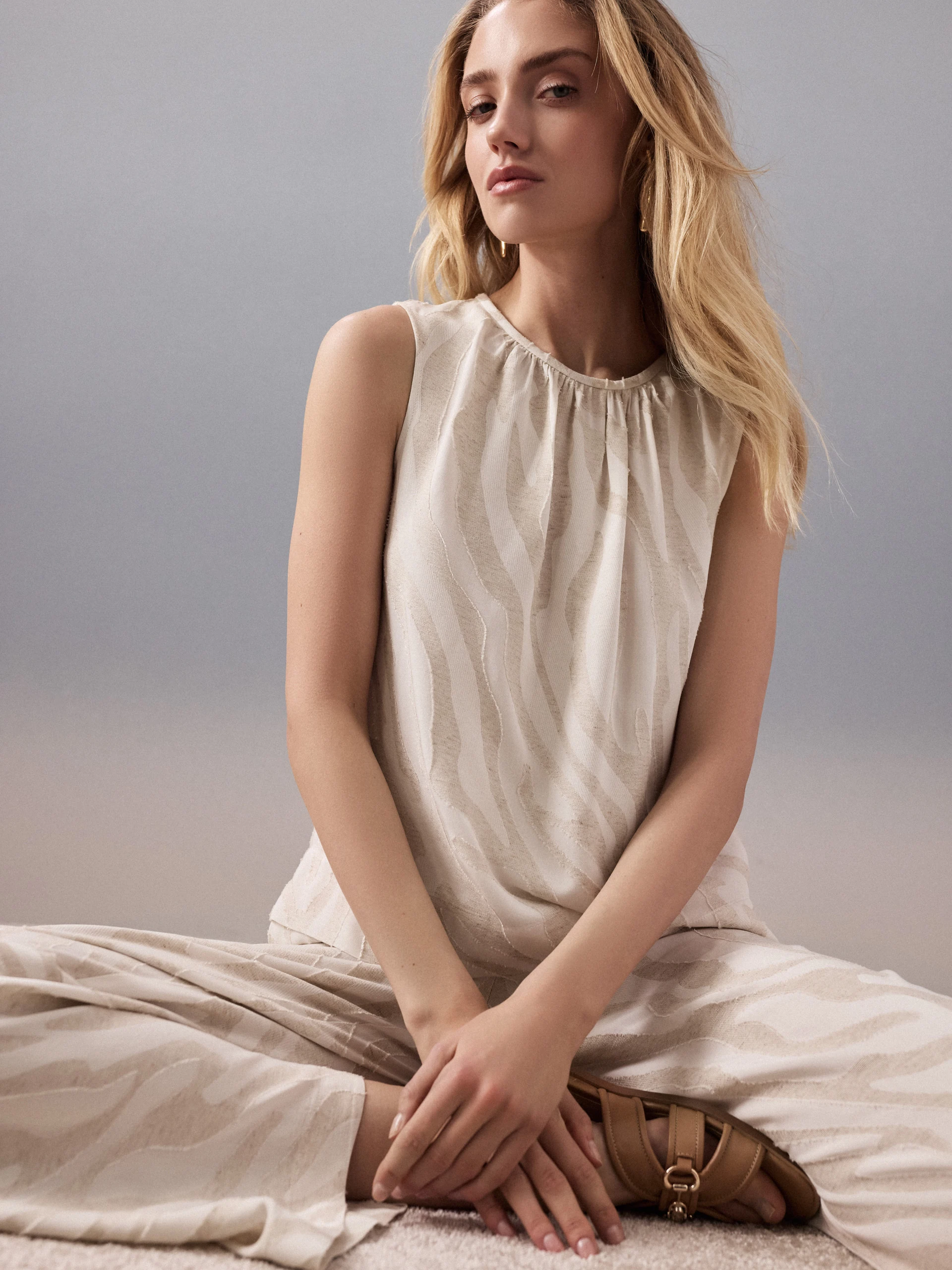 A light-colored blouse with an animal print and linen accents
