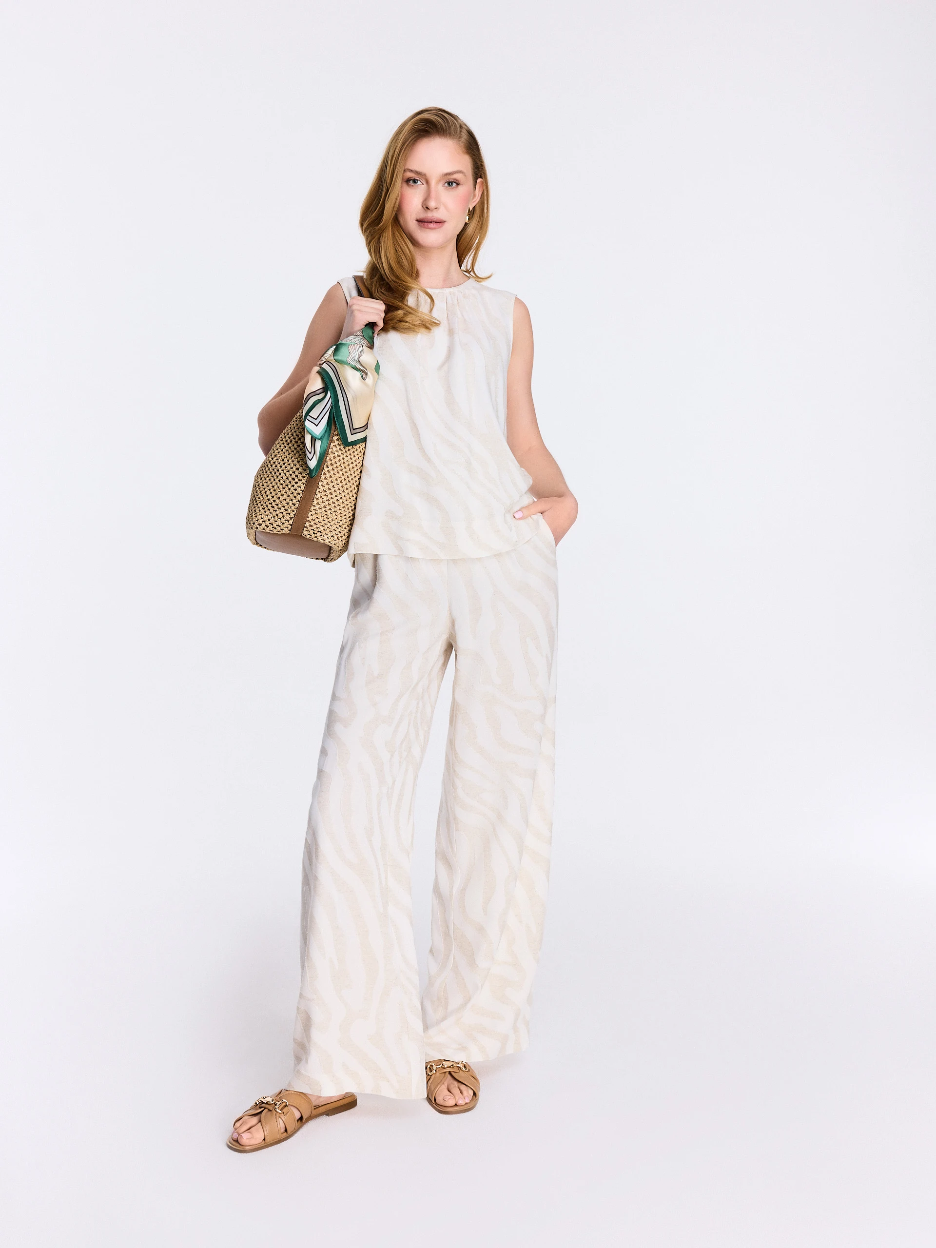 A light-colored blouse with an animal print and linen accents