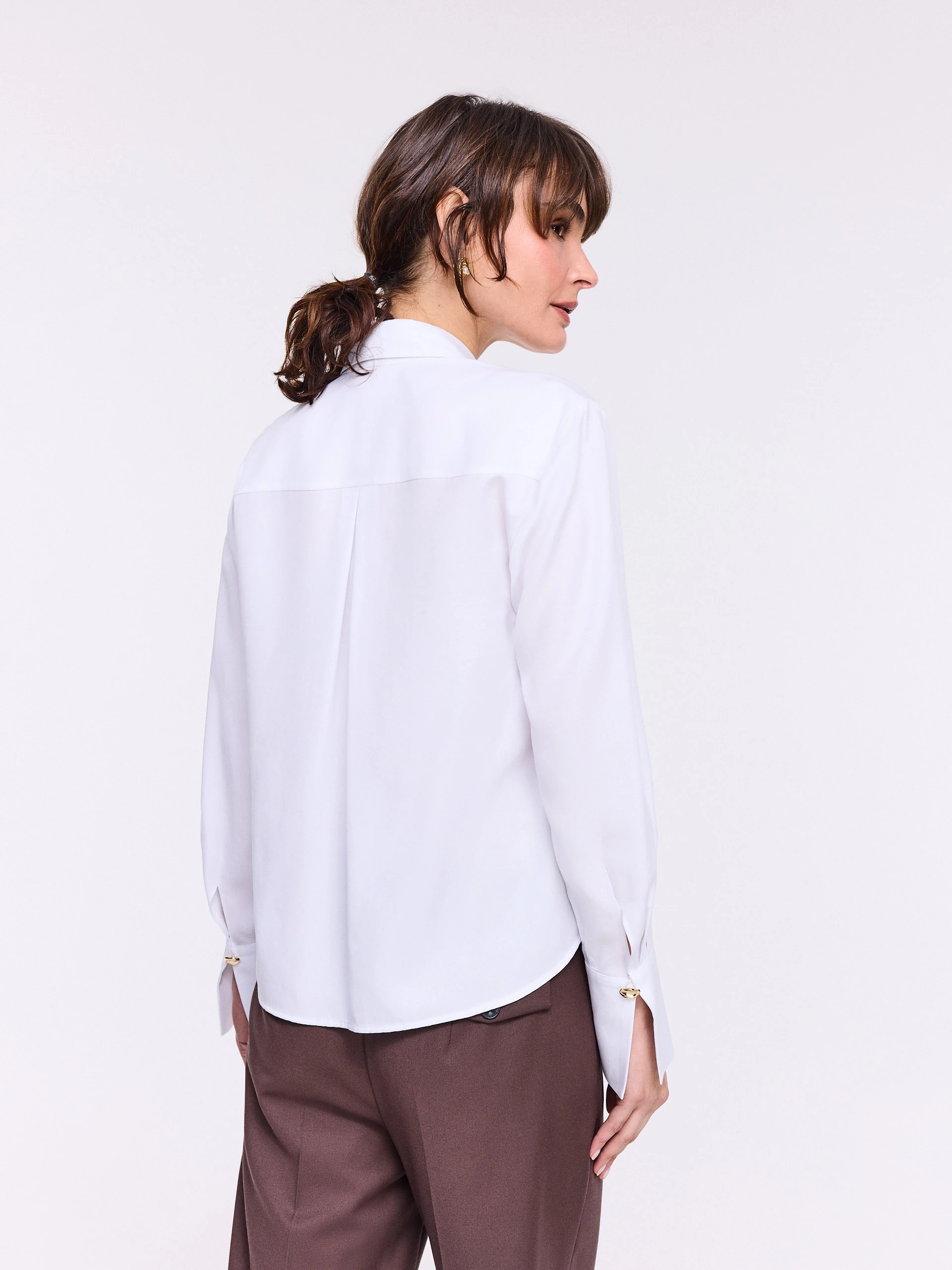 Elegant white shirt with gold-colored buttons
