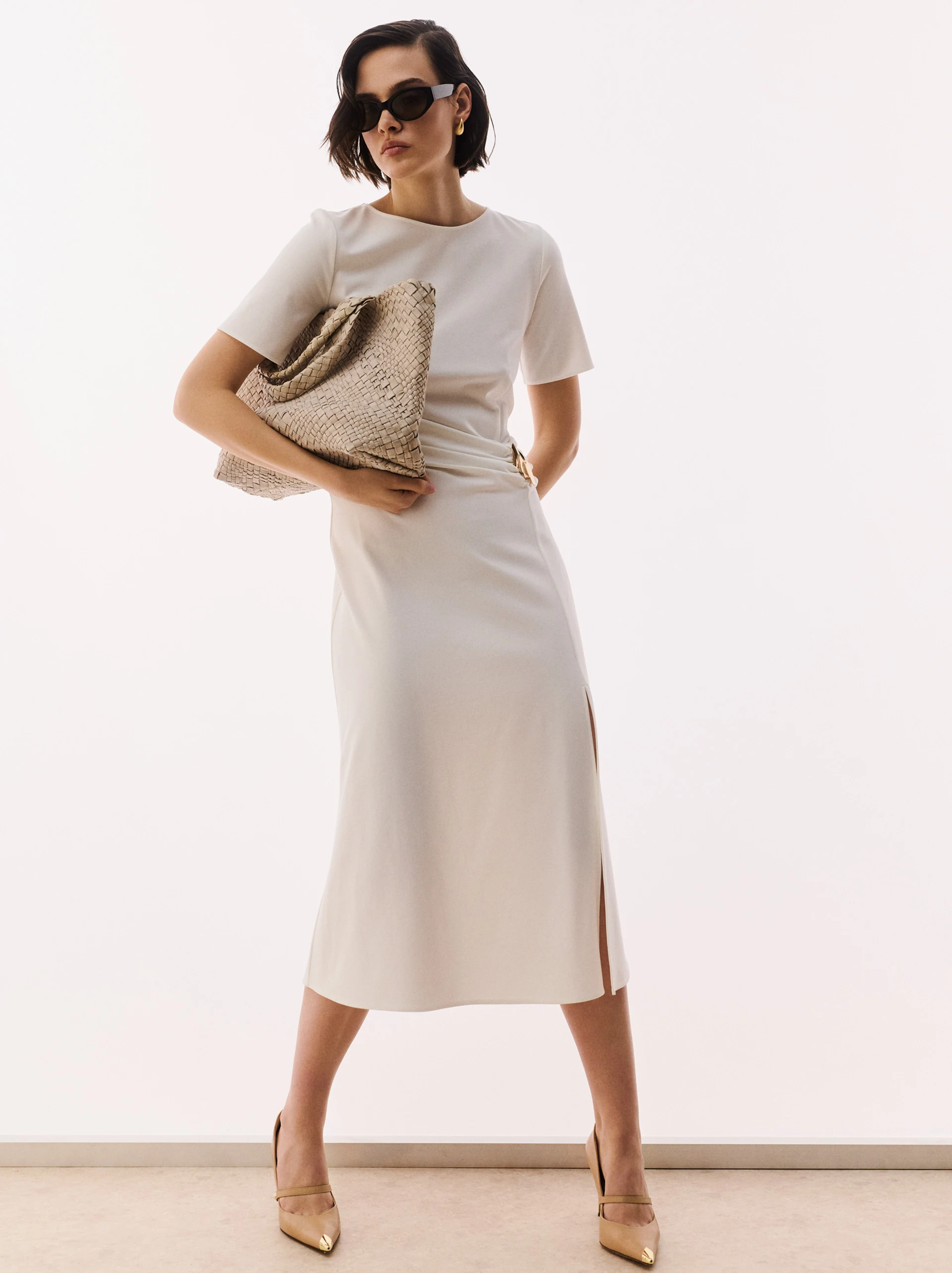 White dress with ruffles and decorative buckle