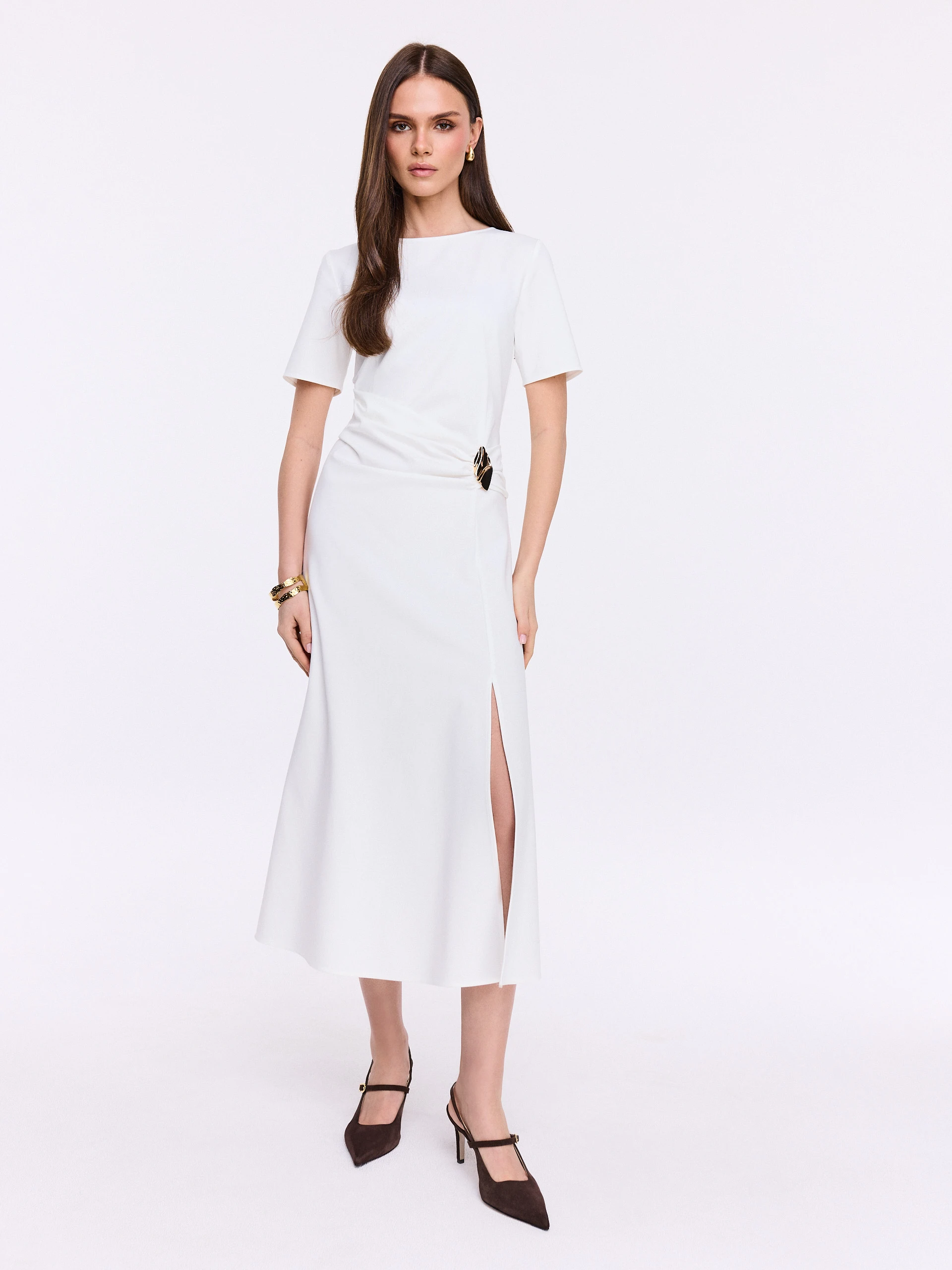 White dress with ruffles and decorative buckle