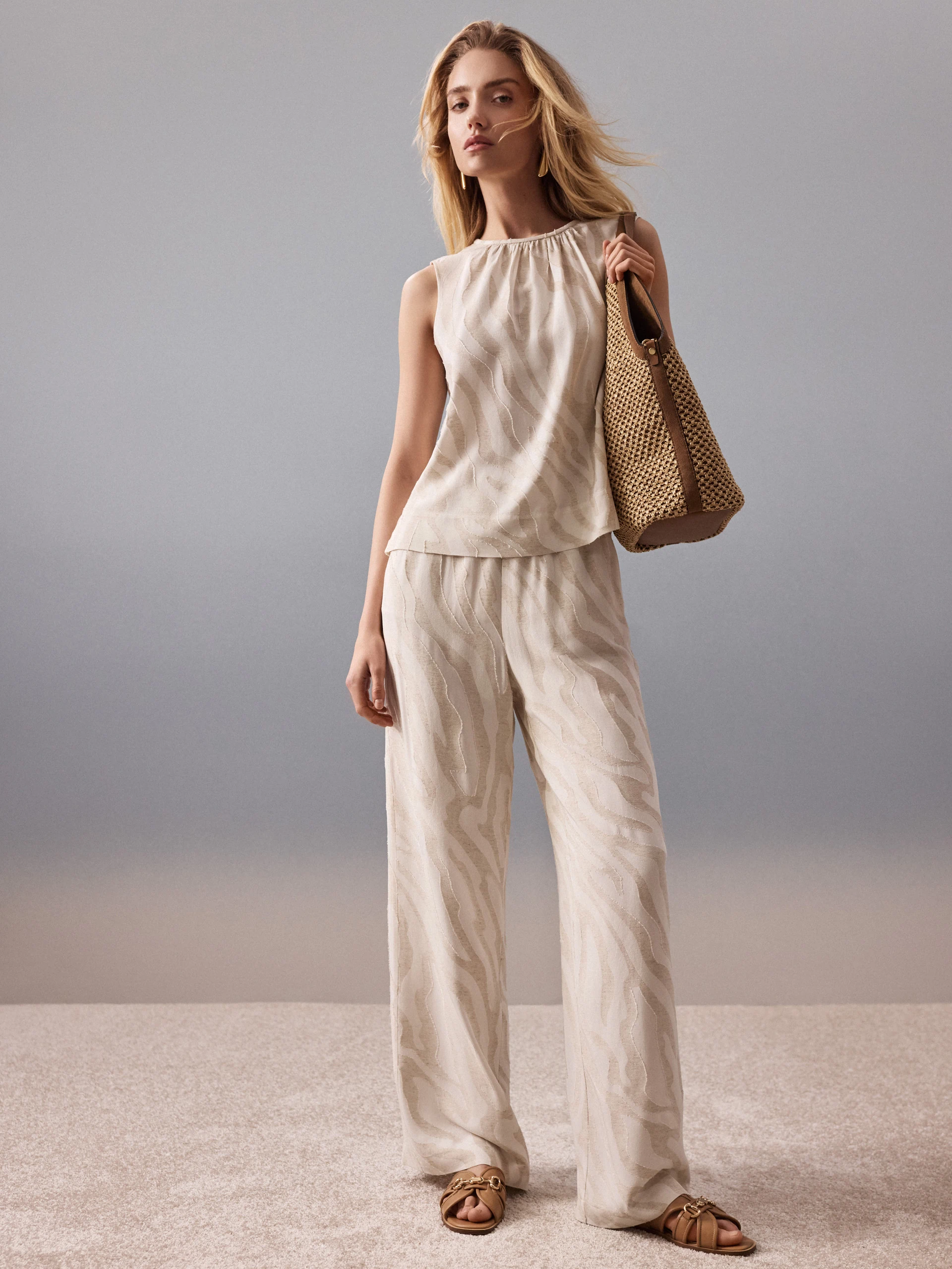 Light-colored pants with an animal print and linen accents