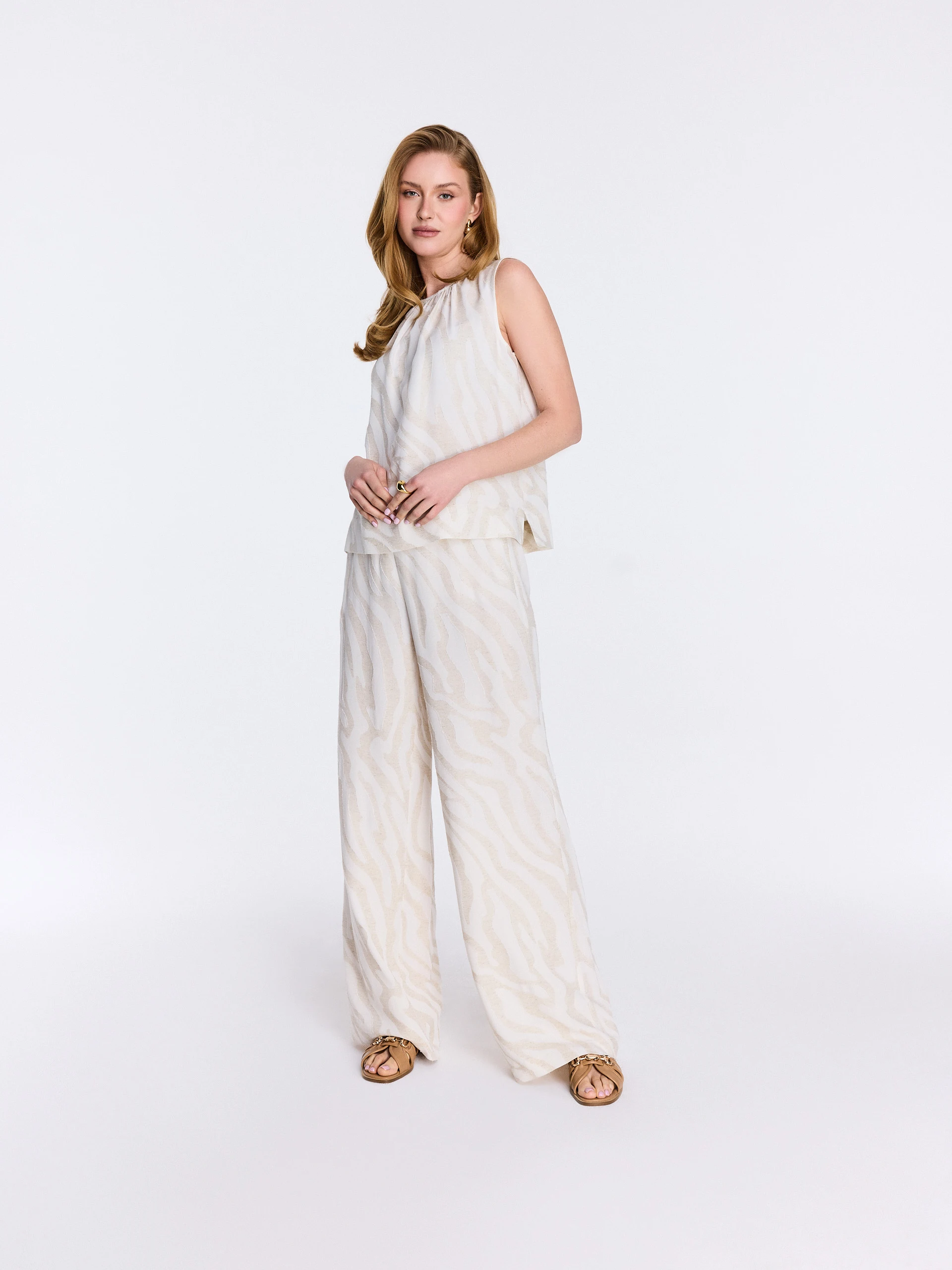 Light-colored pants with an animal print and linen accents