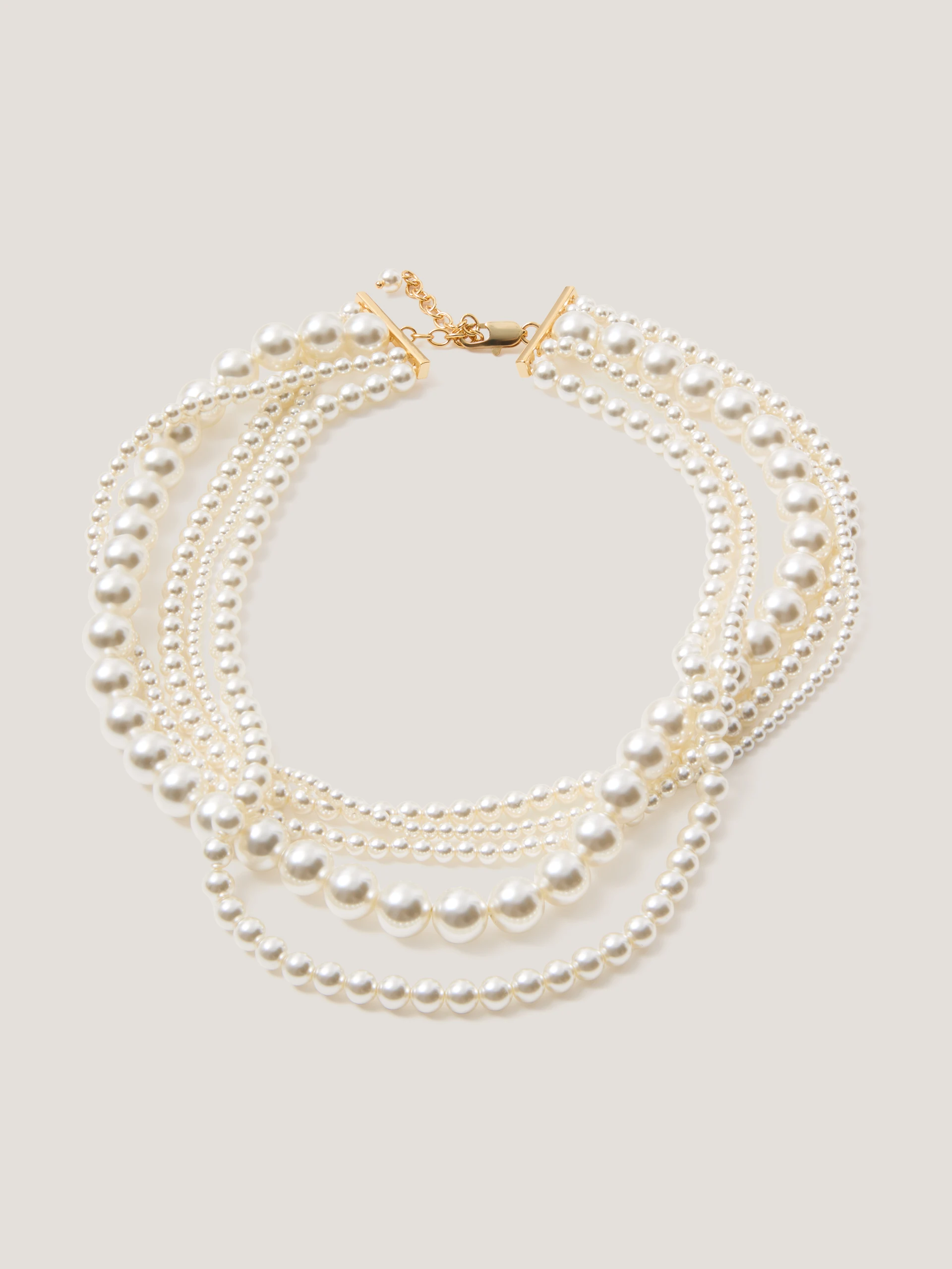 A multi-strand necklace made of pearl beads