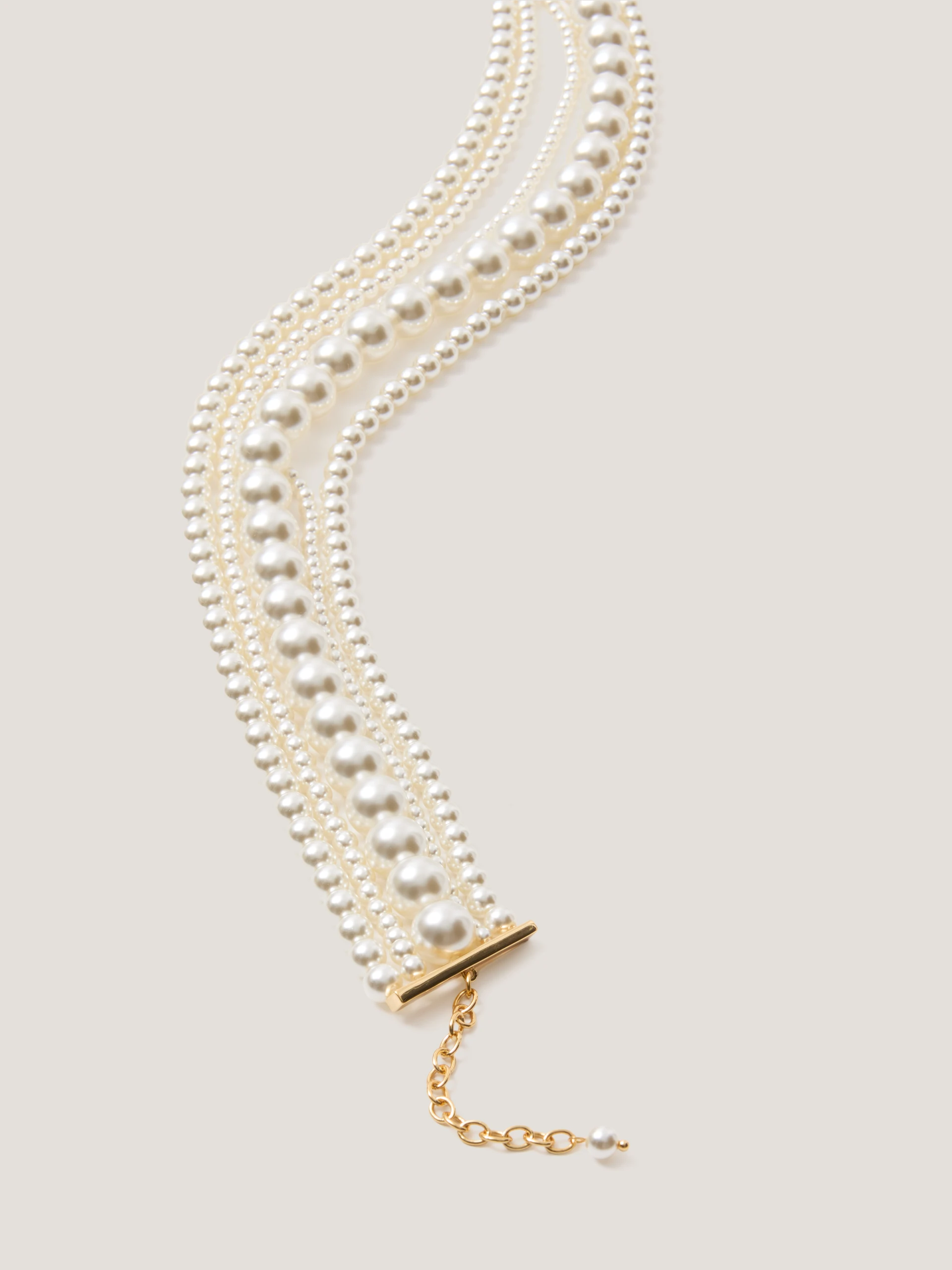 A multi-strand necklace made of pearl beads