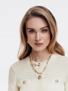 Sweater with openwork inserts and decorative buttons
