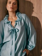 Blue shirt with frills and puffed sleeves