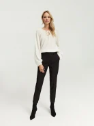 Loose white sweater with tied neckline