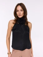 Black blouse with halter neckline and flower at the neck
