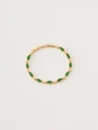 Bracelet in gold color with green crystals