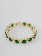 Gold-tone copper bracelet with green zircons