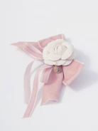 Brooch in the shape of a bow with a flower and a pendant