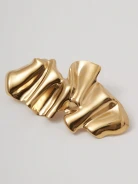 Gold-colored brooch with an irregular shape