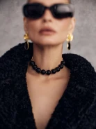 Gold-plated necklace with onyx and hematite stones on a ribbon