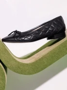 Black quilted leather ballerina flats with bows