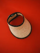 A visor made of natural fibers with decorative trim