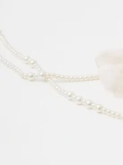 Double necklace made of glass pearls with flowers